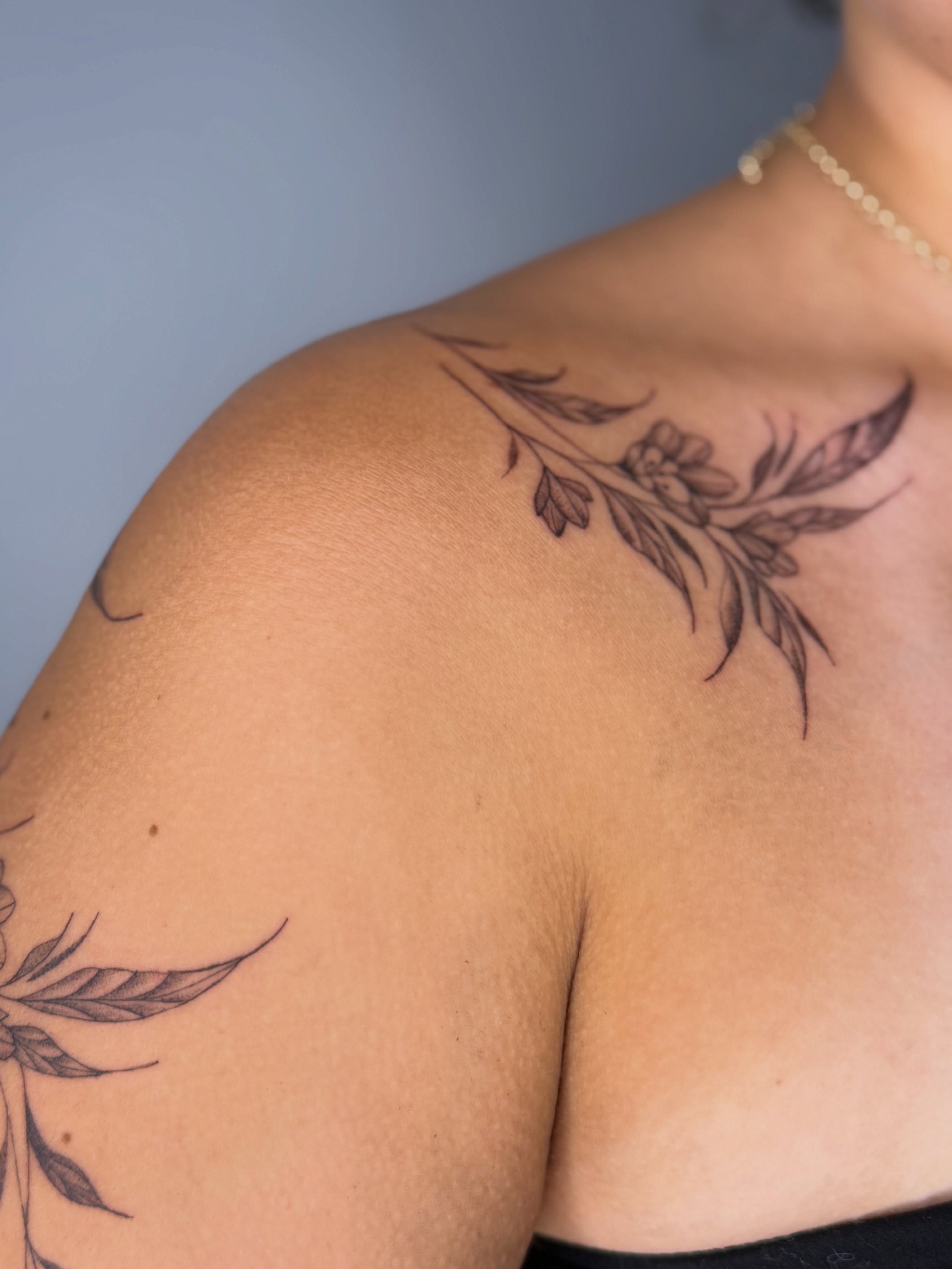Floral branch black and grey tattoo on the shoulder by Silva Wellen