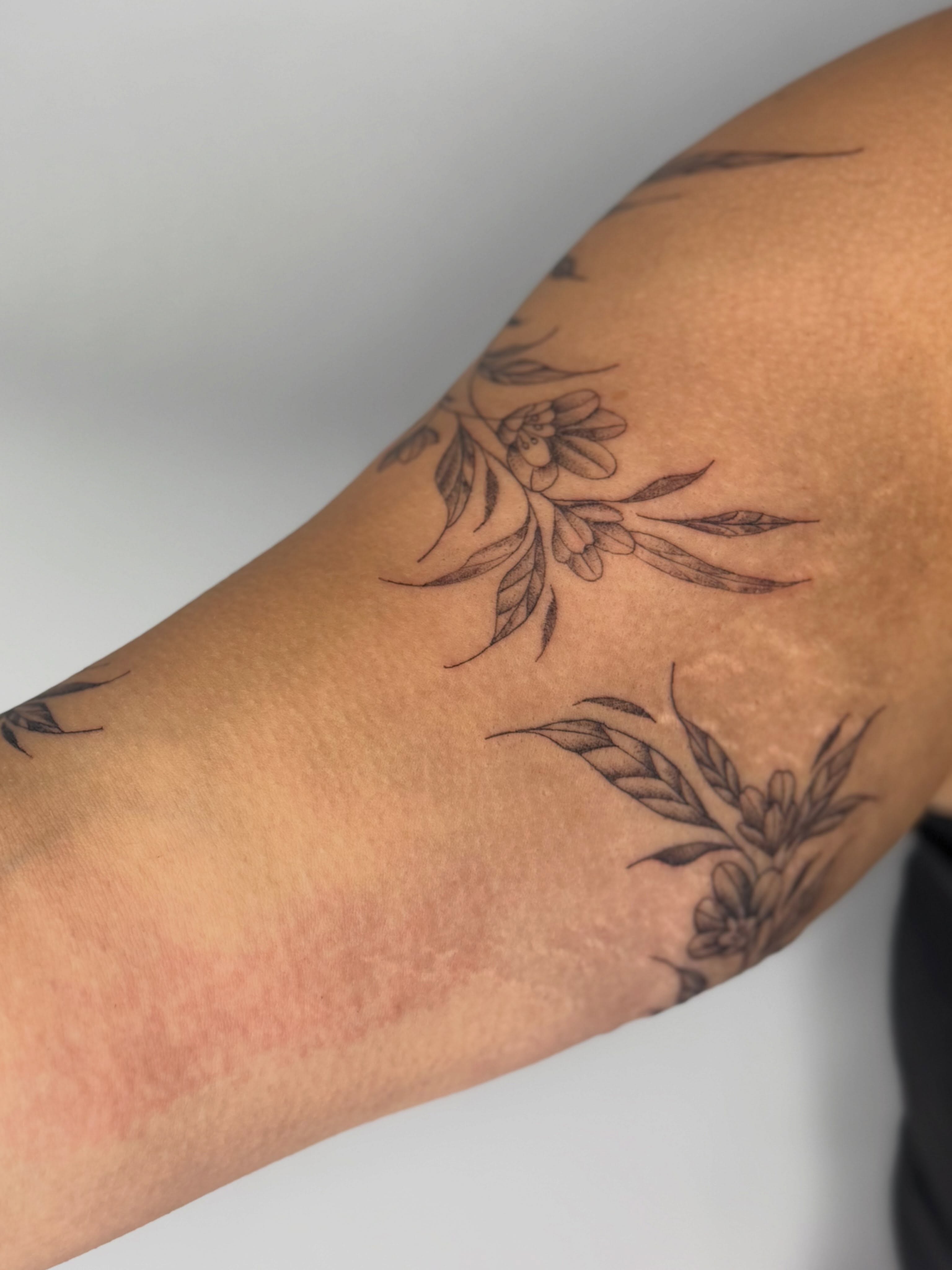 Floral design black and grey tattoo on the forearm by Silva Wellen