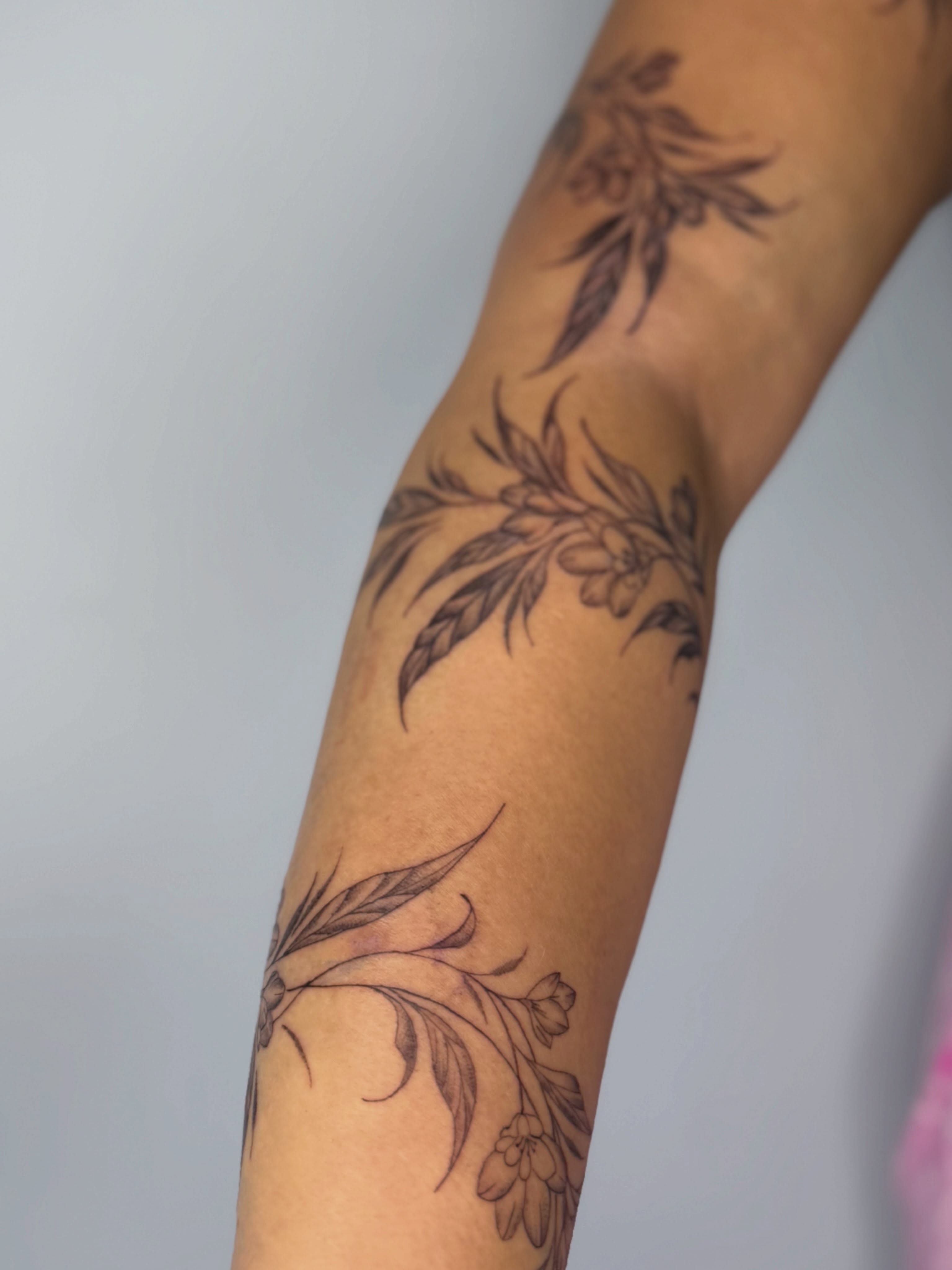 Floral arrangement black and grey tattoo on the forearm by Silva Wellen