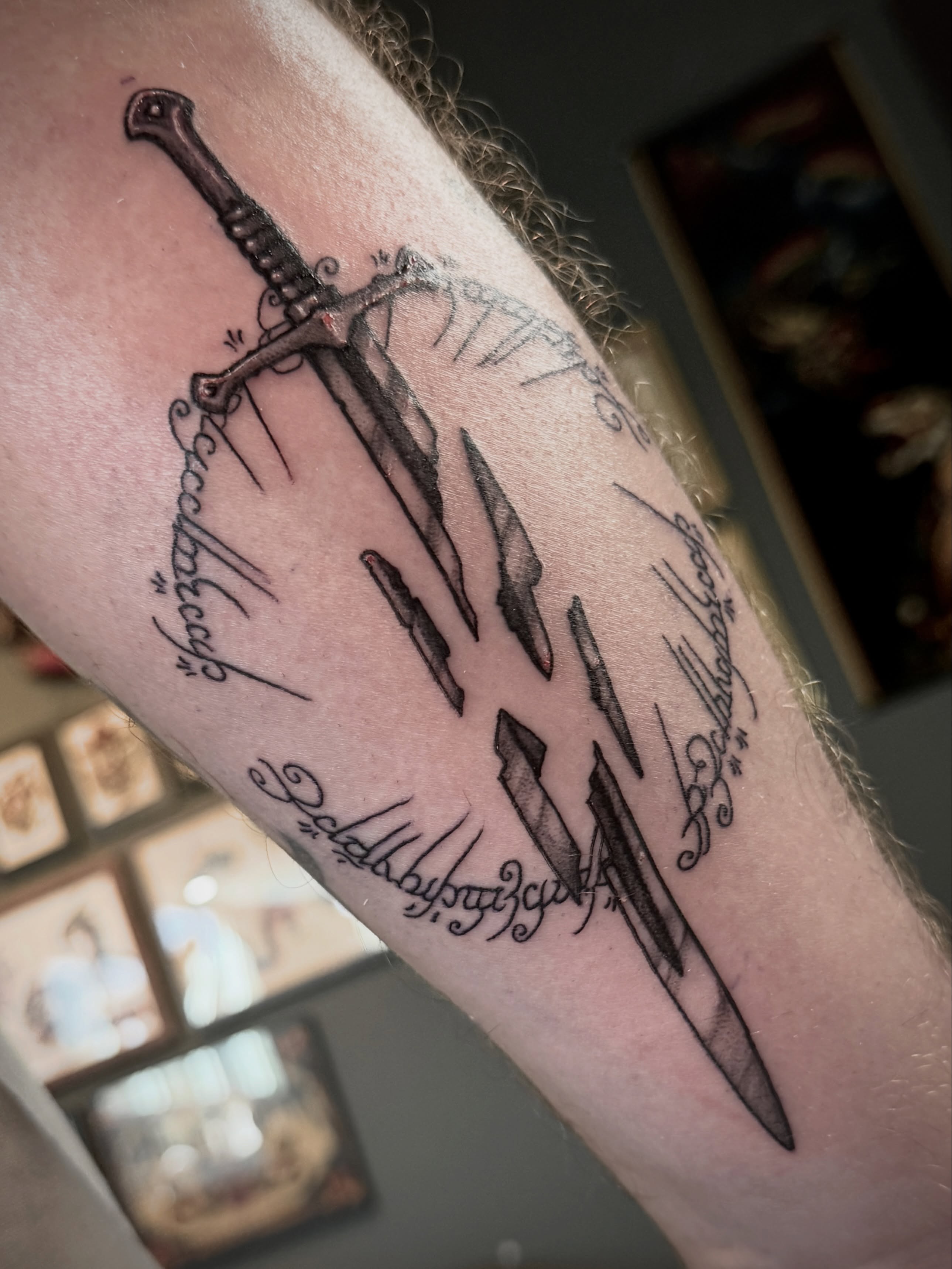 Sword and runes black and grey tattoo on the forearm by Luisa Gonzalez, Austin, Texas
