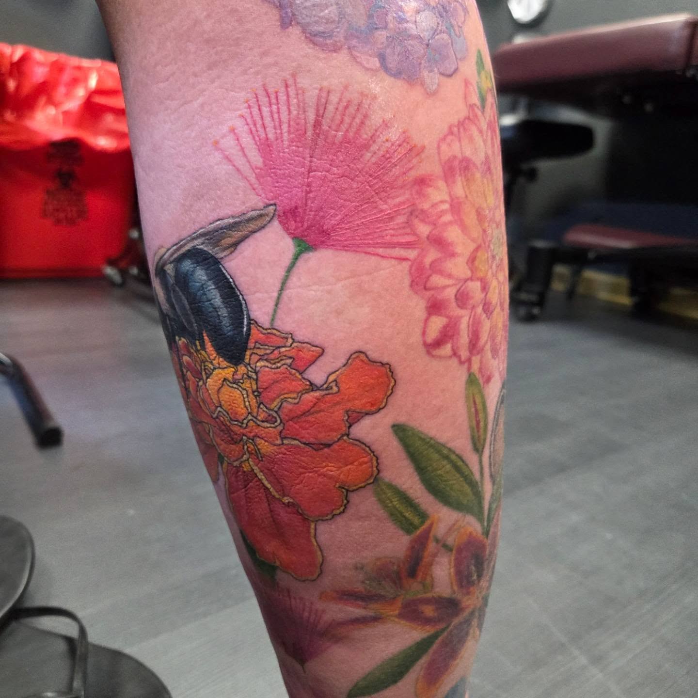 Beetle and flowers realism tattoo on the forearm by Trinity Renee
