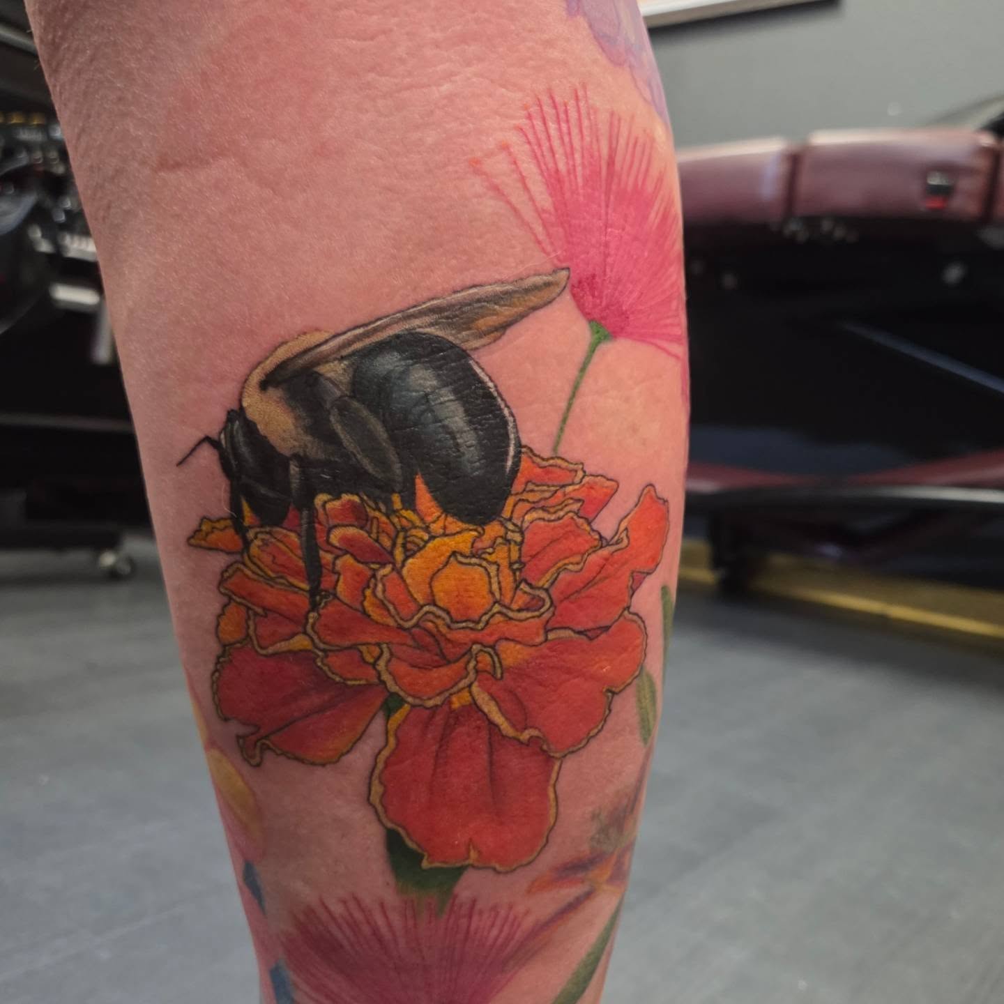 Bee and flower realism tattoo on the forearm by Trinity Renee