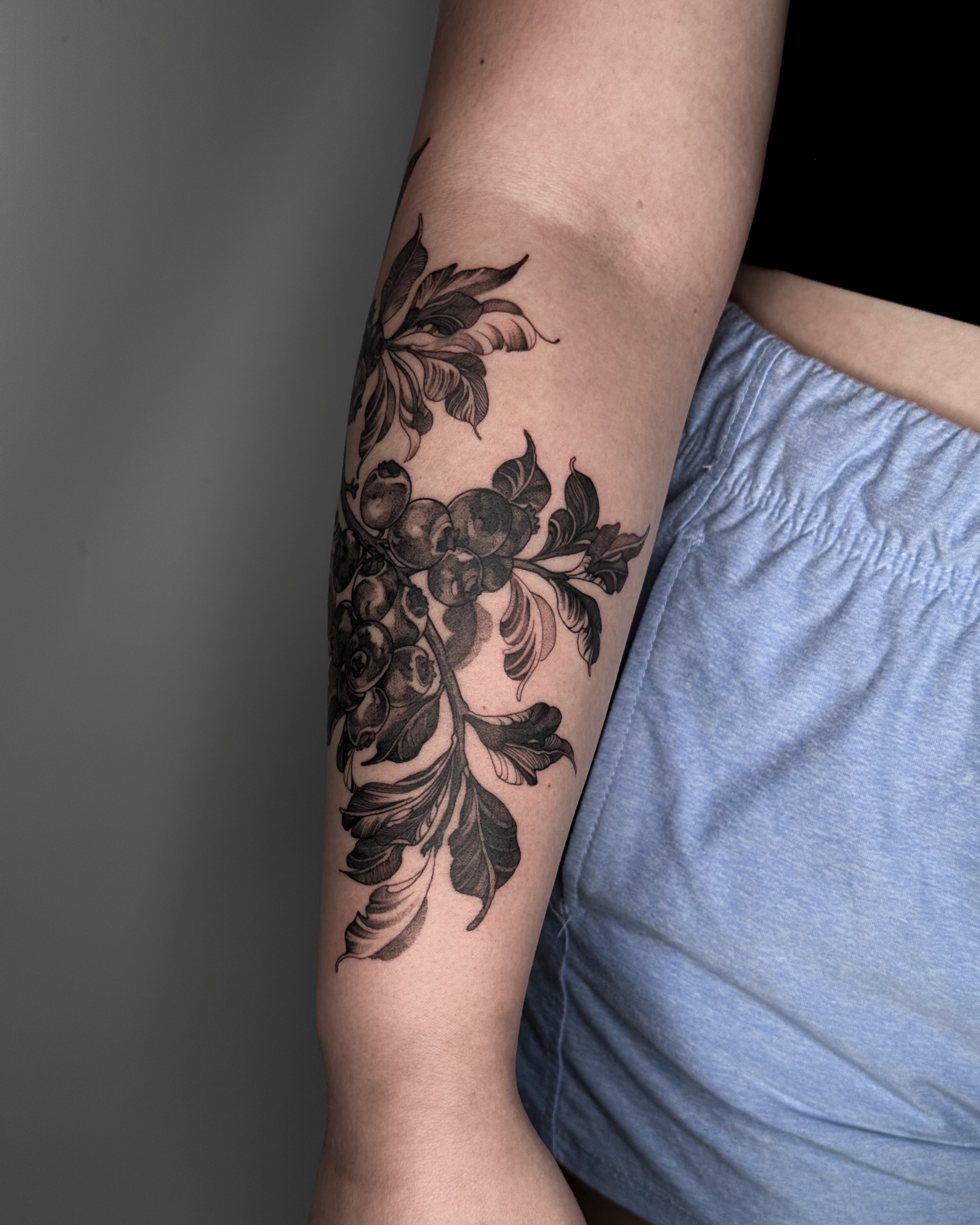 Floral arrangement black and grey tattoo on the forearm by Luiny
