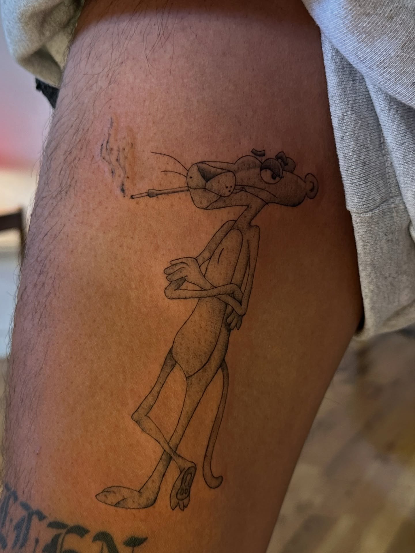 Pink panther black and grey tattoo on the thigh by @taravychi