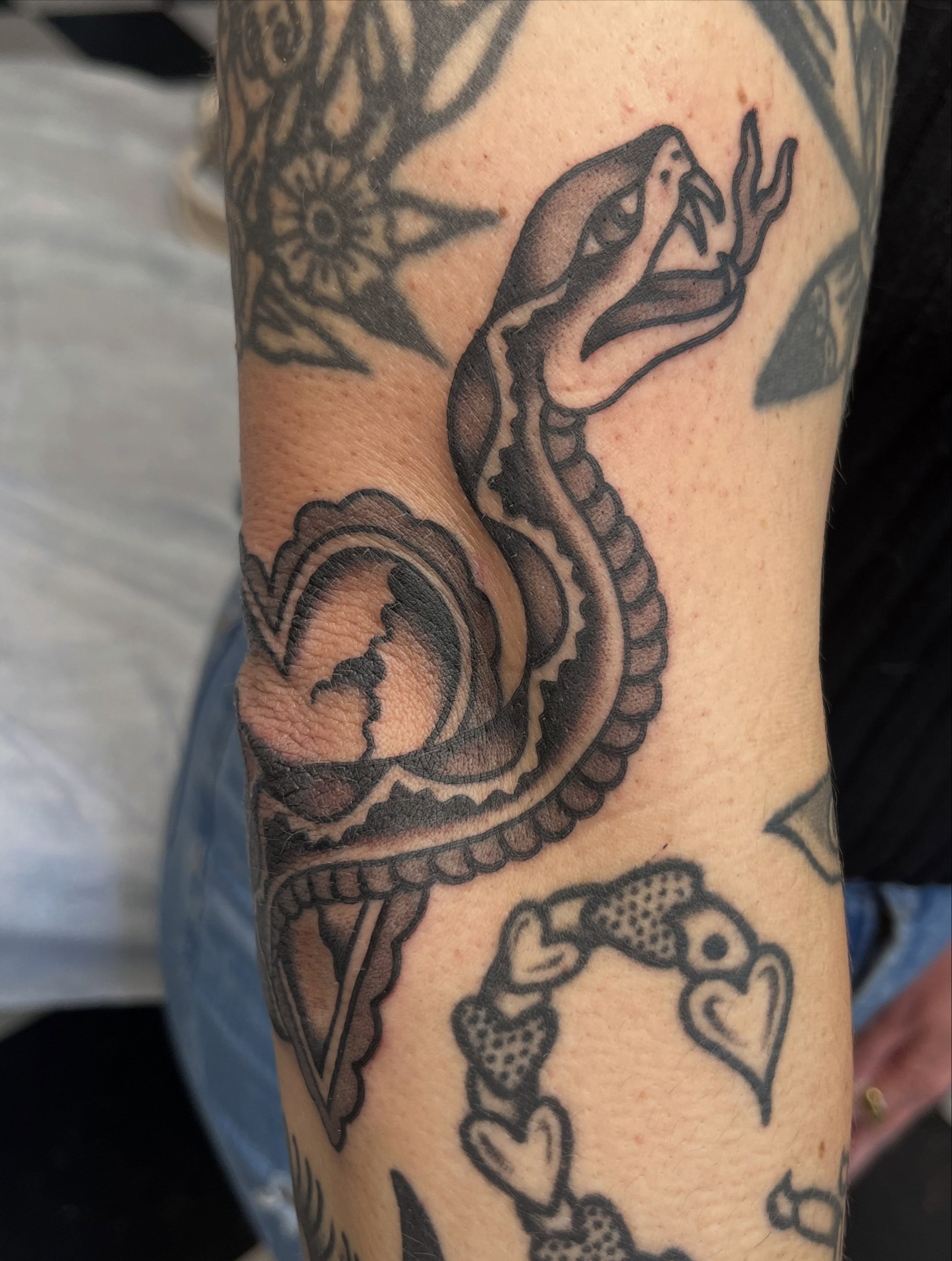 Snake black and grey tattoo on the forearm by Kayla Gibson, Portland, Oregon