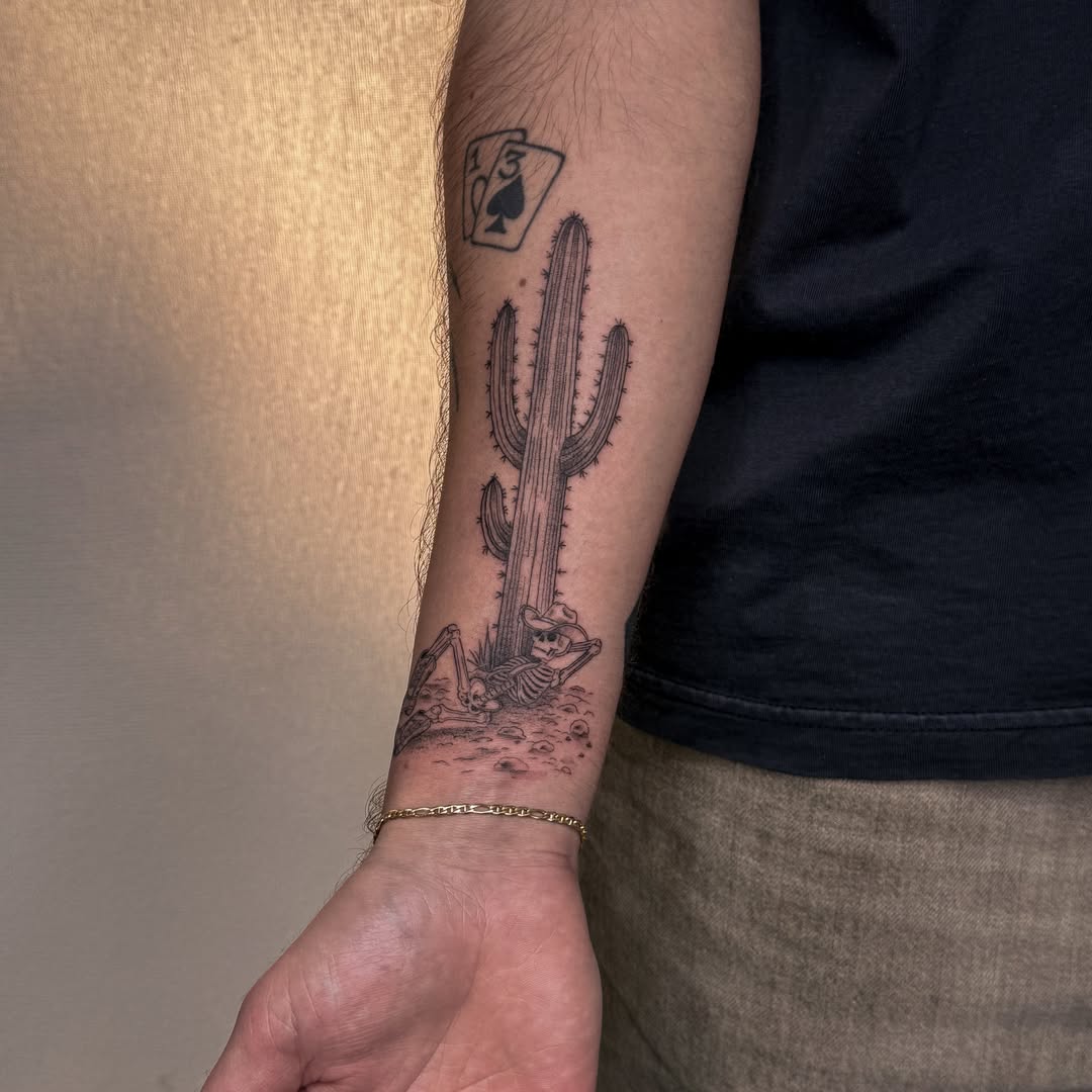 Cactus and cowboy black and grey tattoo on the forearm by Las Vegas Tattoo Artist