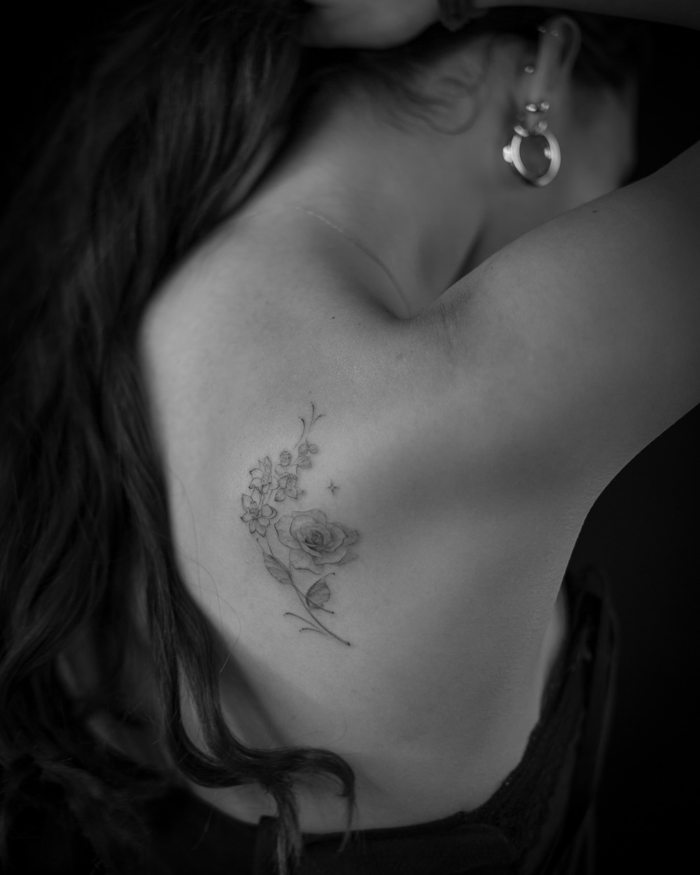 Flower arrangement black and grey tattoo on the chest by Aries Rising