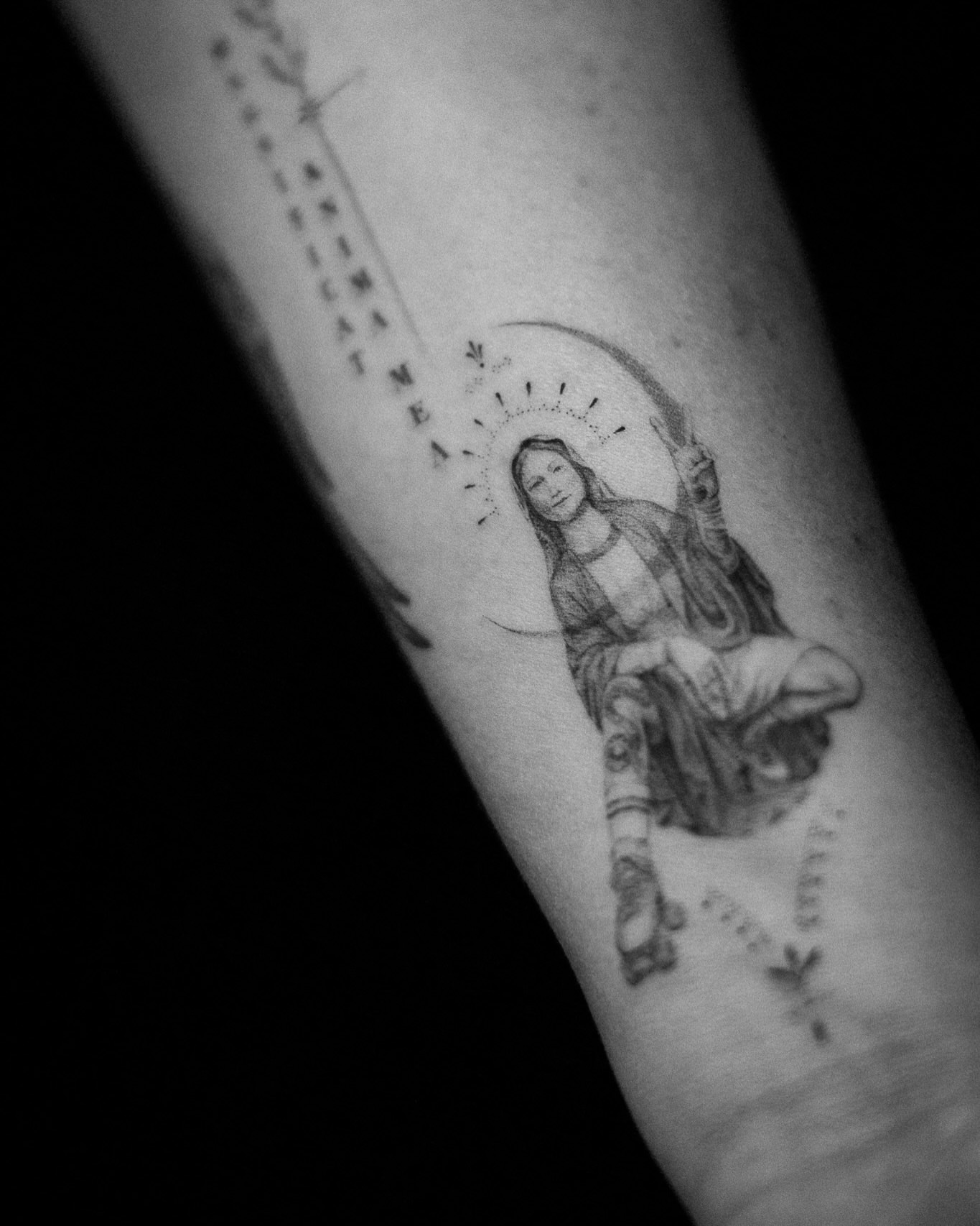 Religious figure black and grey tattoo on the forearm by Aries Rising