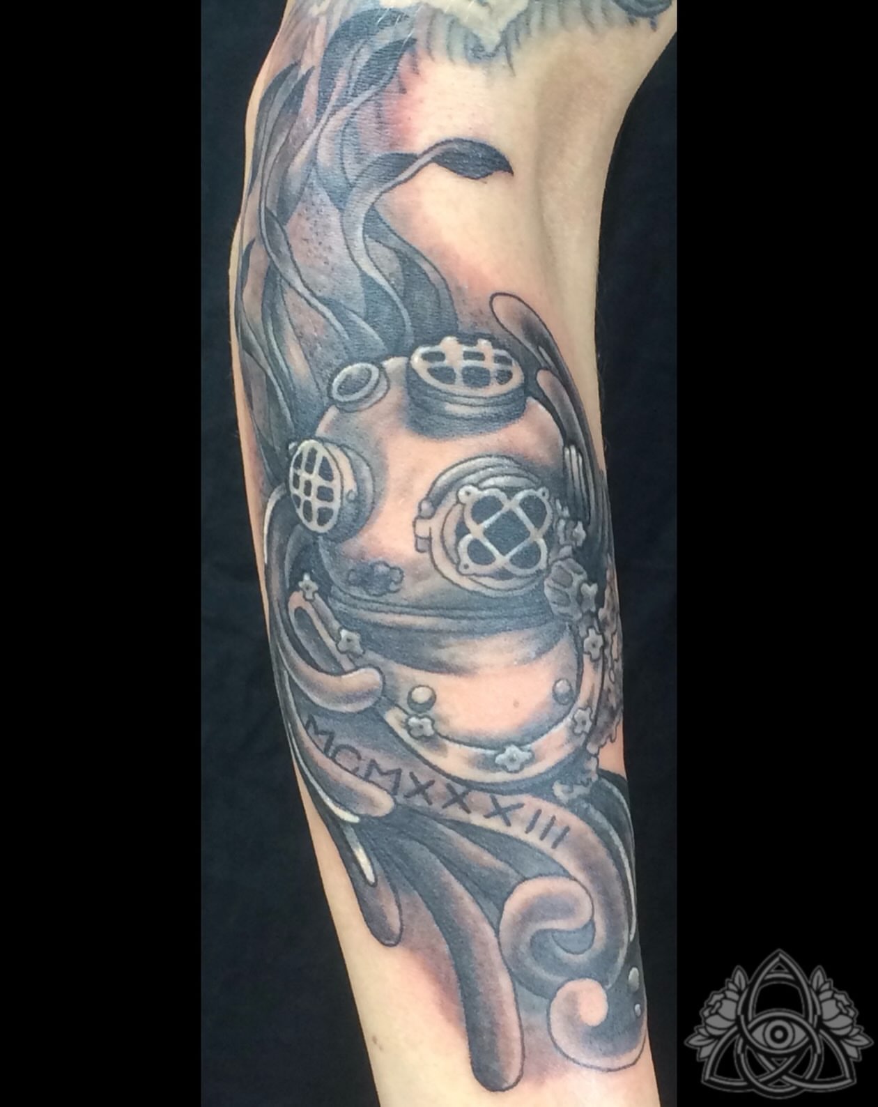 Diving helmet black and grey tattoo on the forearm by Michael - Tattoo Garden Everett, Everett, Washington