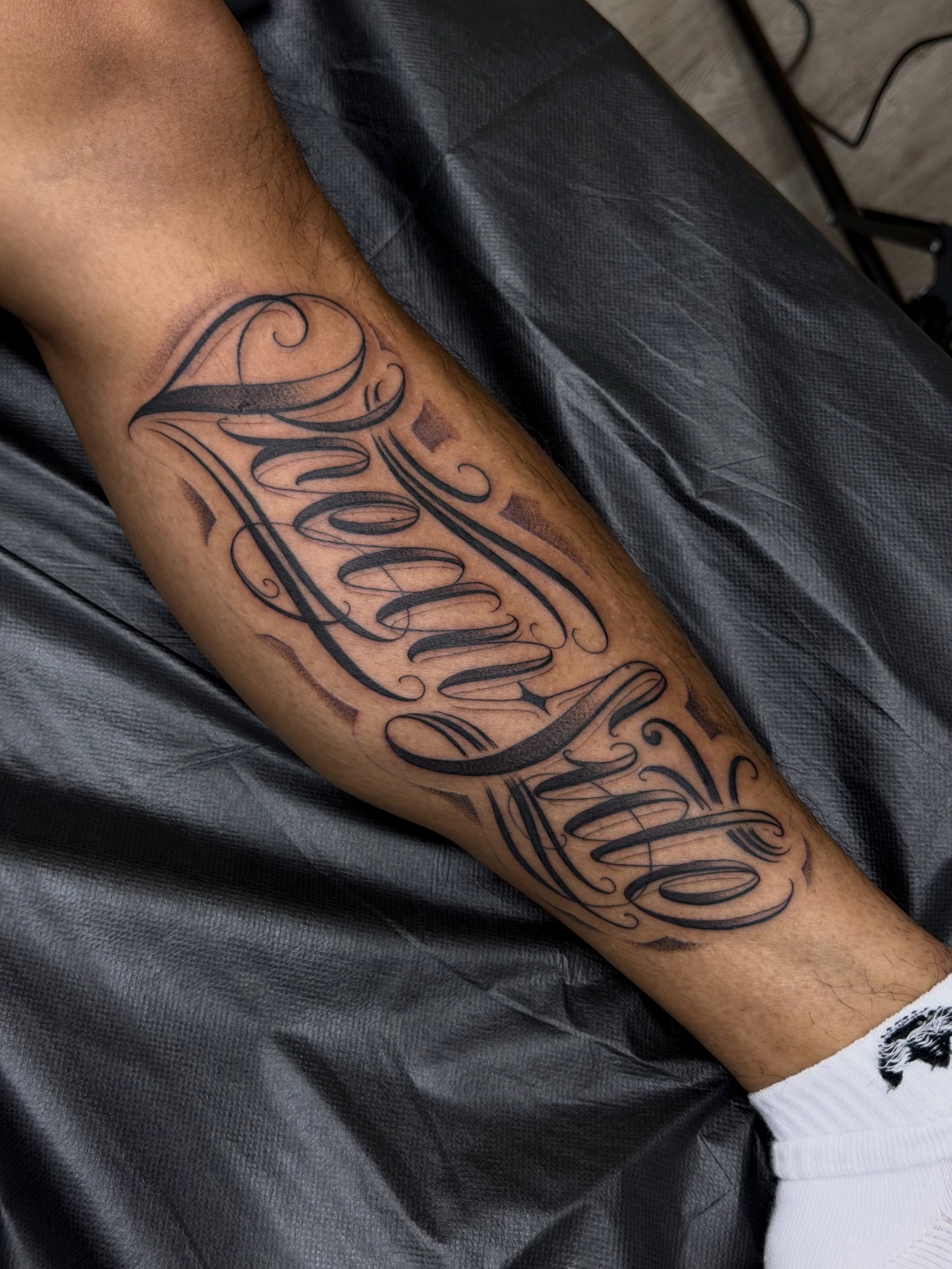 Script lettering lettering script tattoo on the forearm by San Diego Tattoo Artist