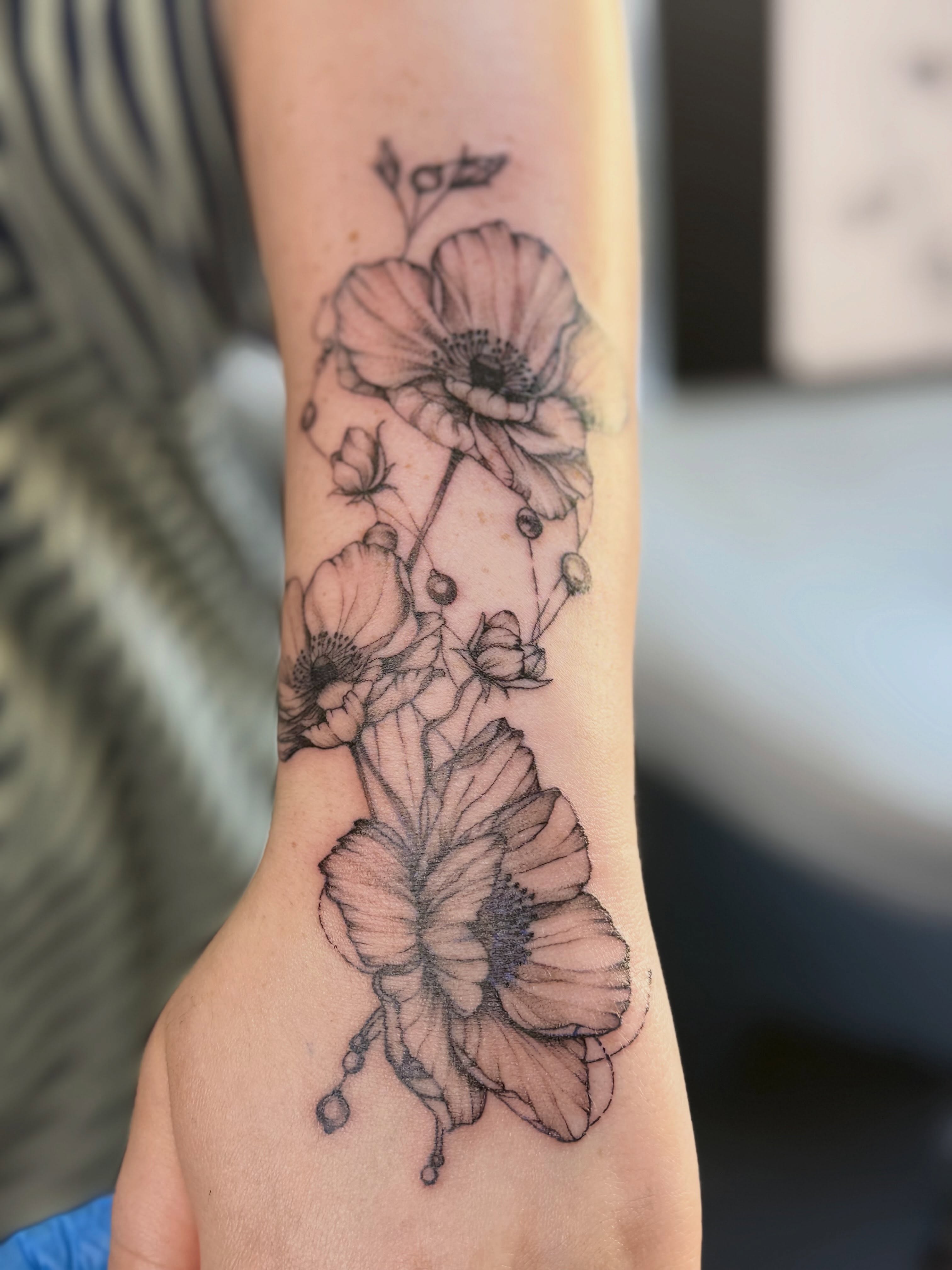 Poppy flowers black and grey tattoo on the forearm by Tetiana