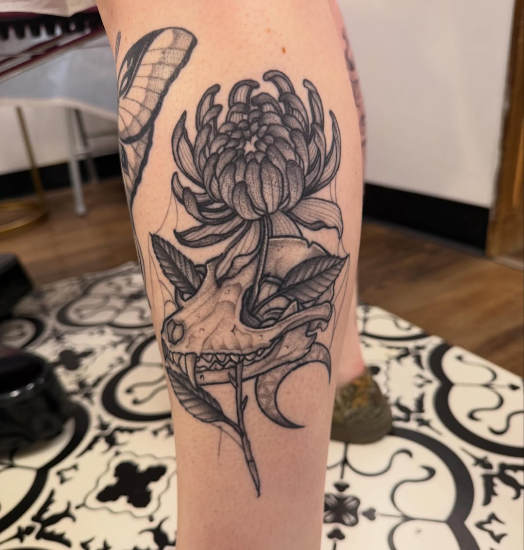 Chrysanthemum and skull realism tattoo on the forearm by Ashleigh Lapole