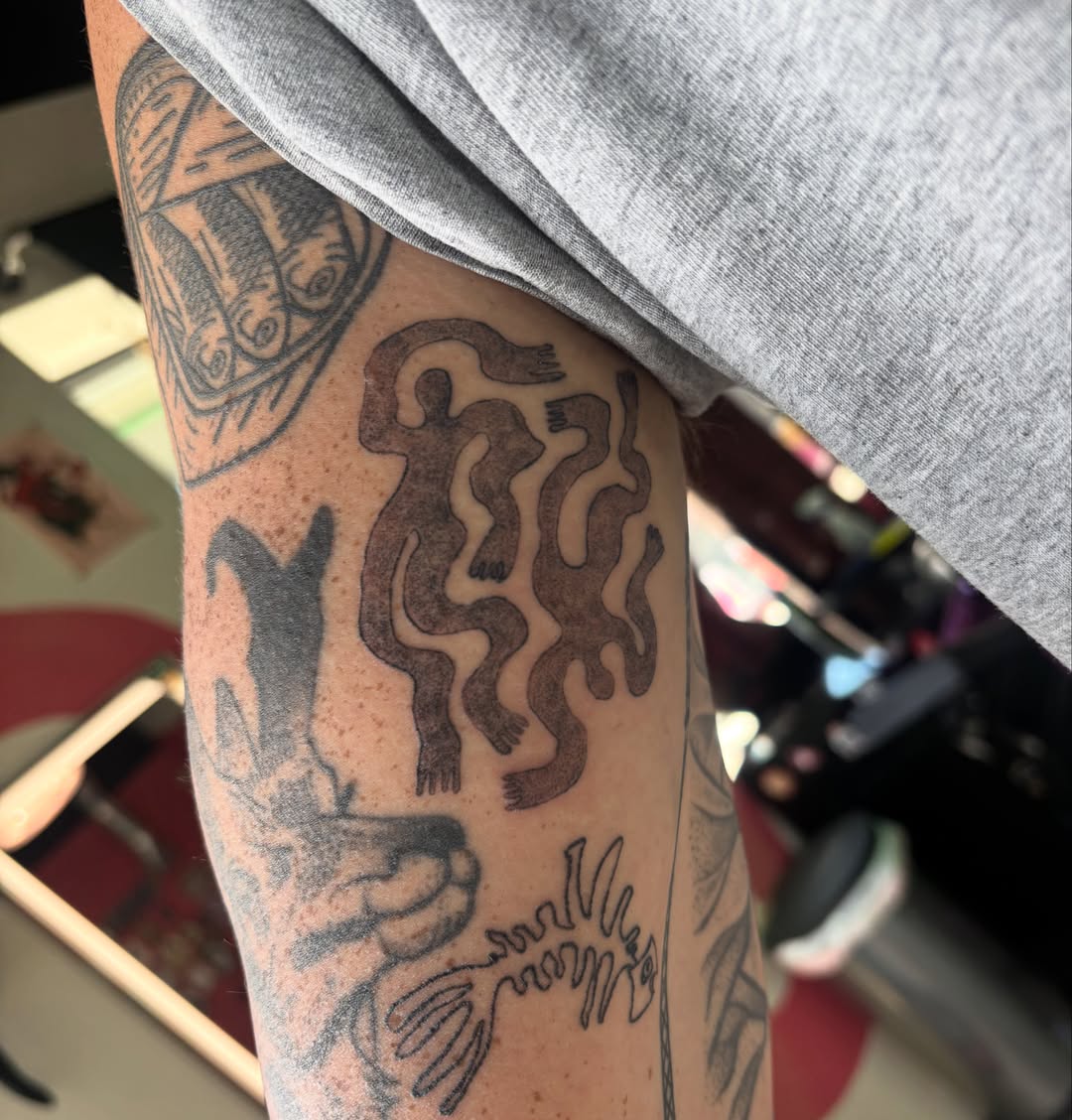 Abstract figure black and grey tattoo on the forearm by Hiro Robinson