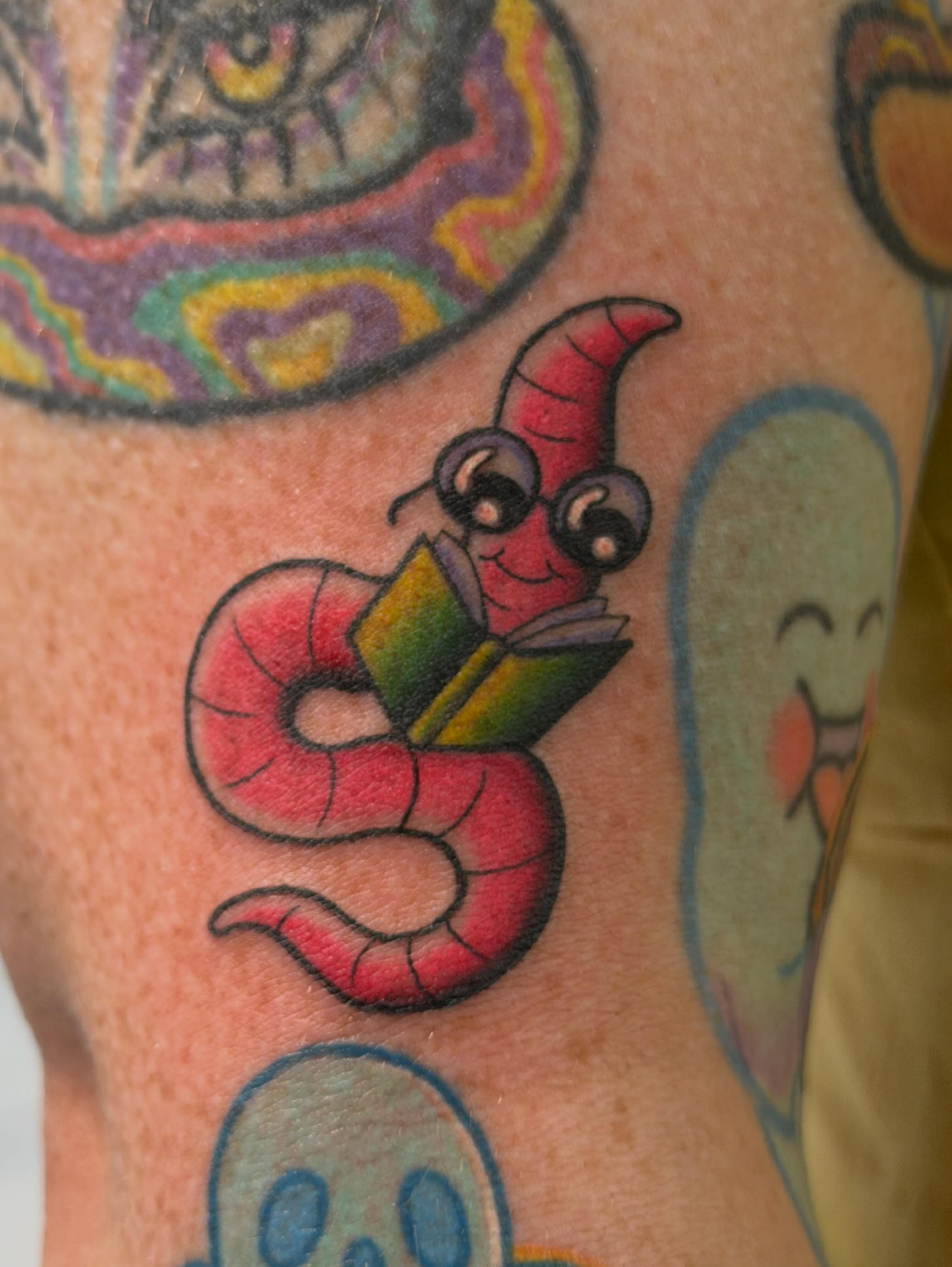 Worm reading book new school tattoo on the forearm by ♥︎ ᴅᴇᴠ ʀᴇɴᴇᴇ ♥︎