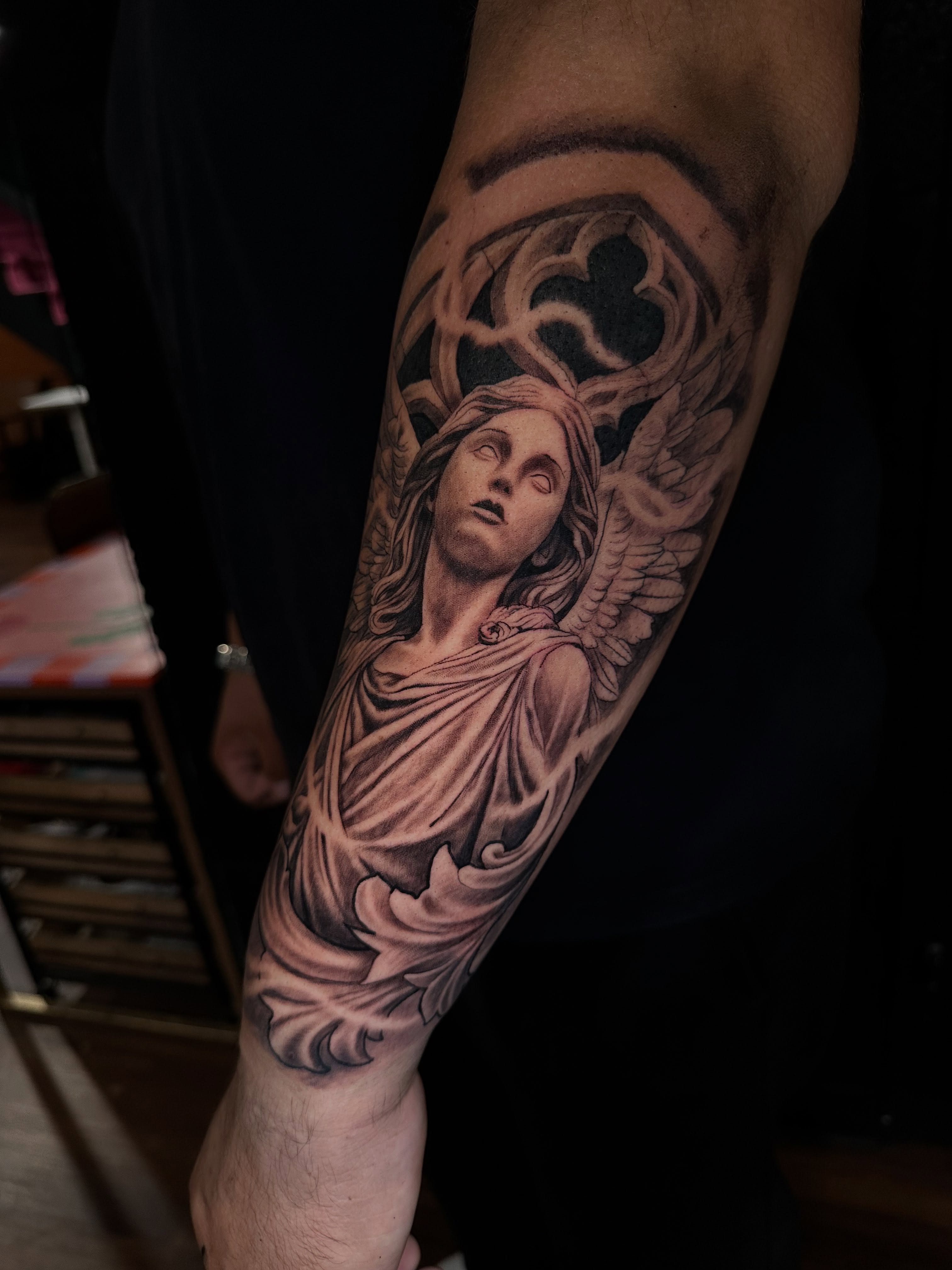 Angel statue realism tattoo on the forearm by Mario Flores Tattoo