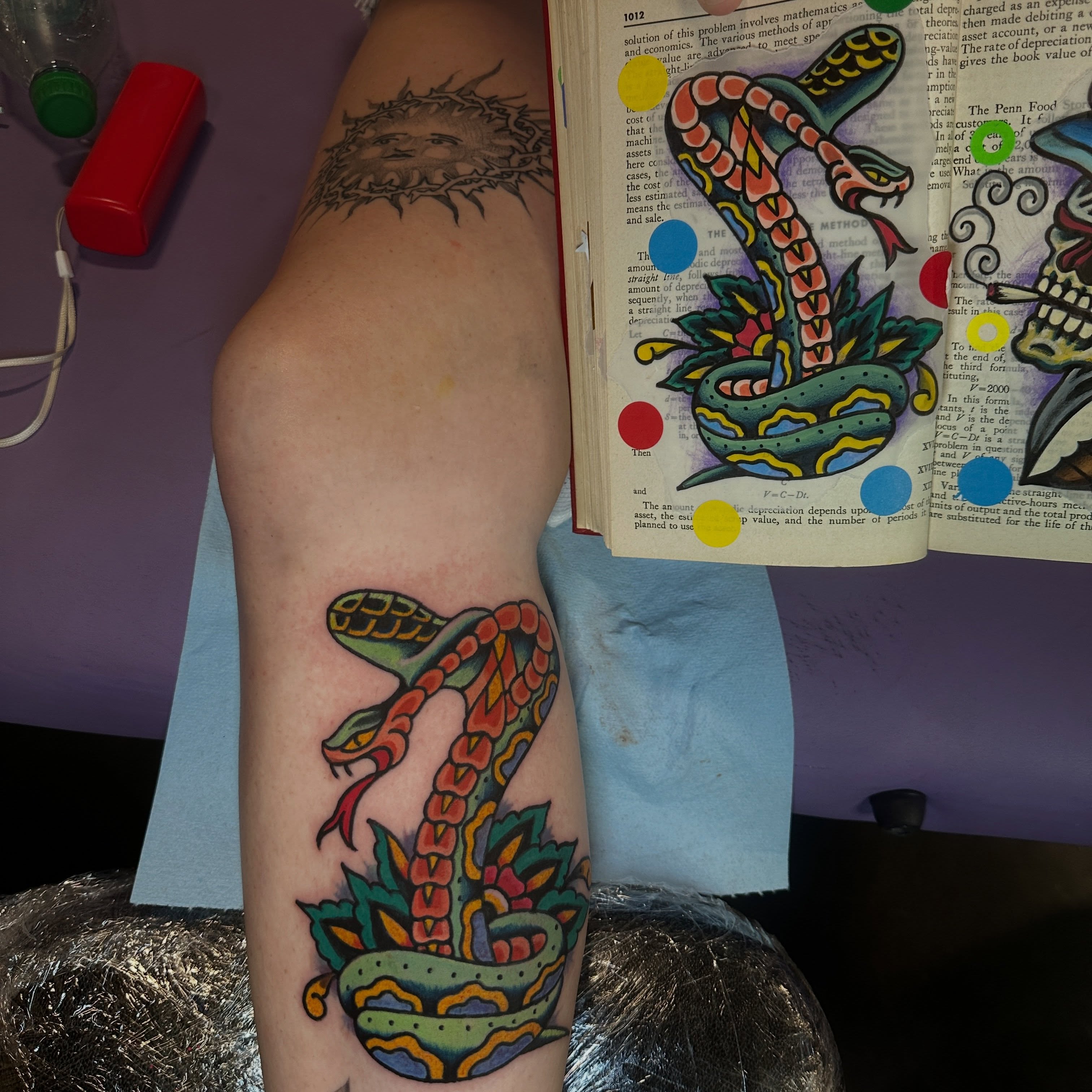 Snake and plant American traditional tattoo on the forearm by Matthew Tattooer Harman