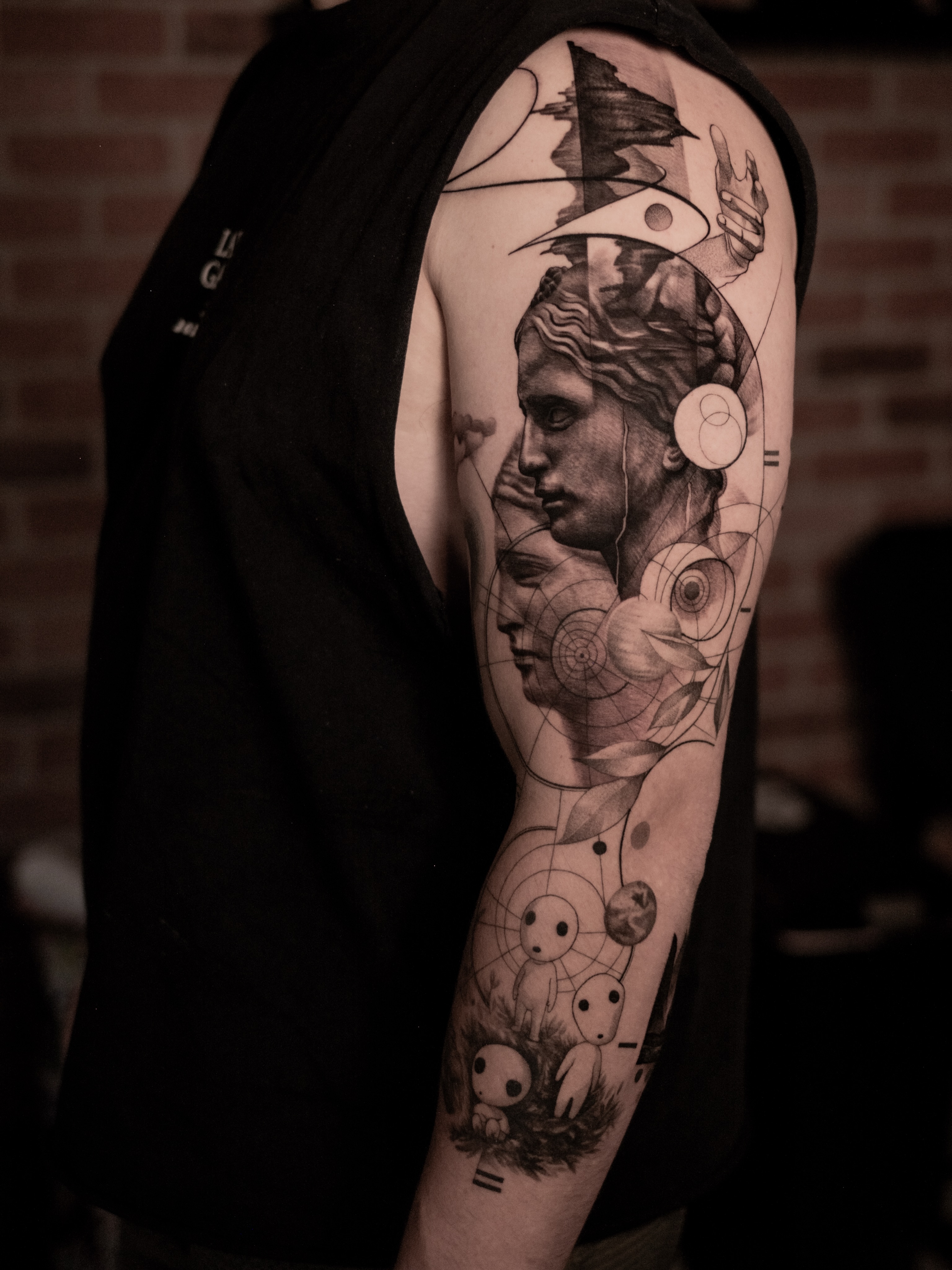 Statue and abstract elements geometric tattoo on the forearm by Mark D, Los Angeles, California