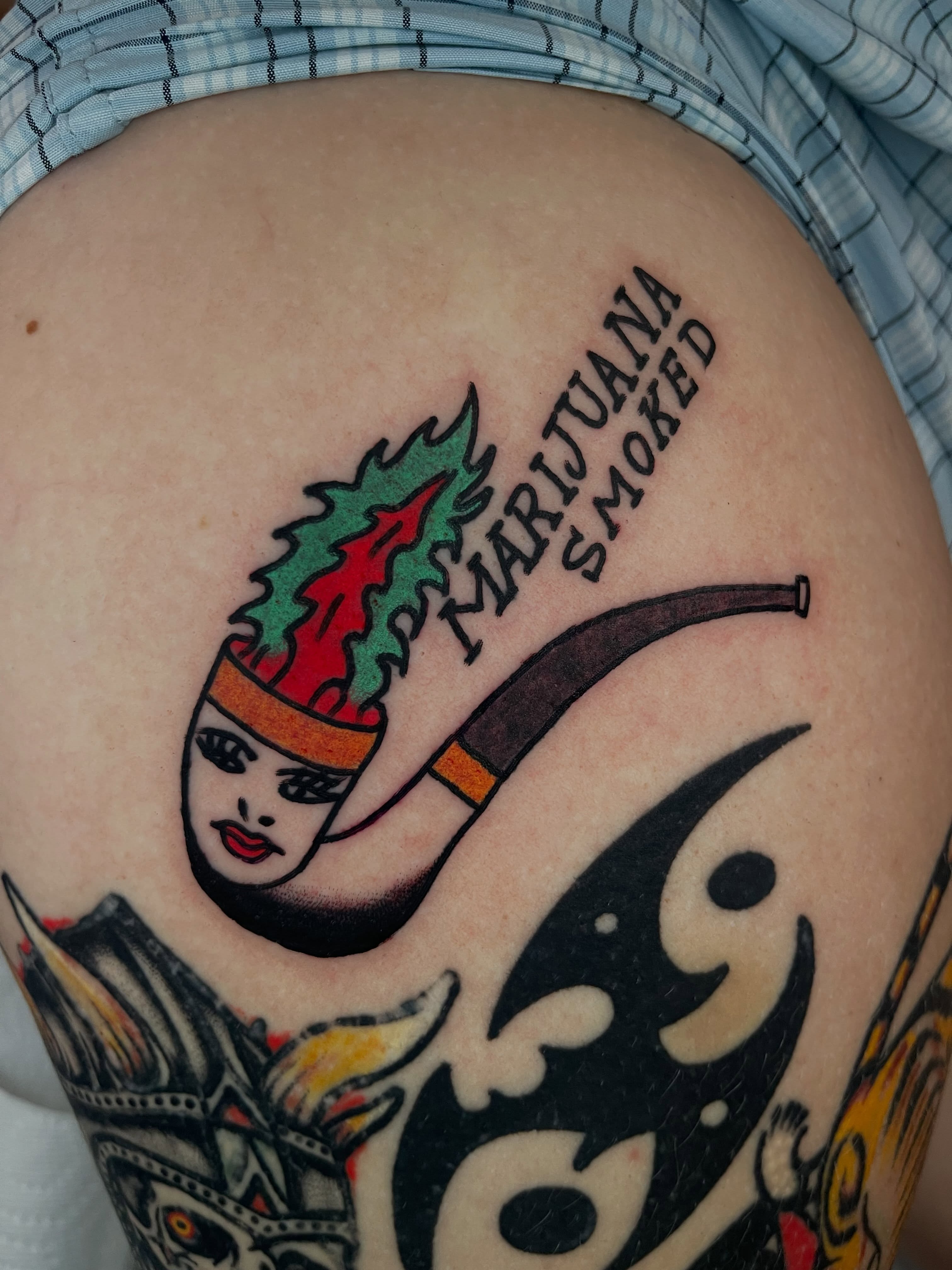 Marijuana pipe American traditional tattoo on the thigh by Devyn Hightower
