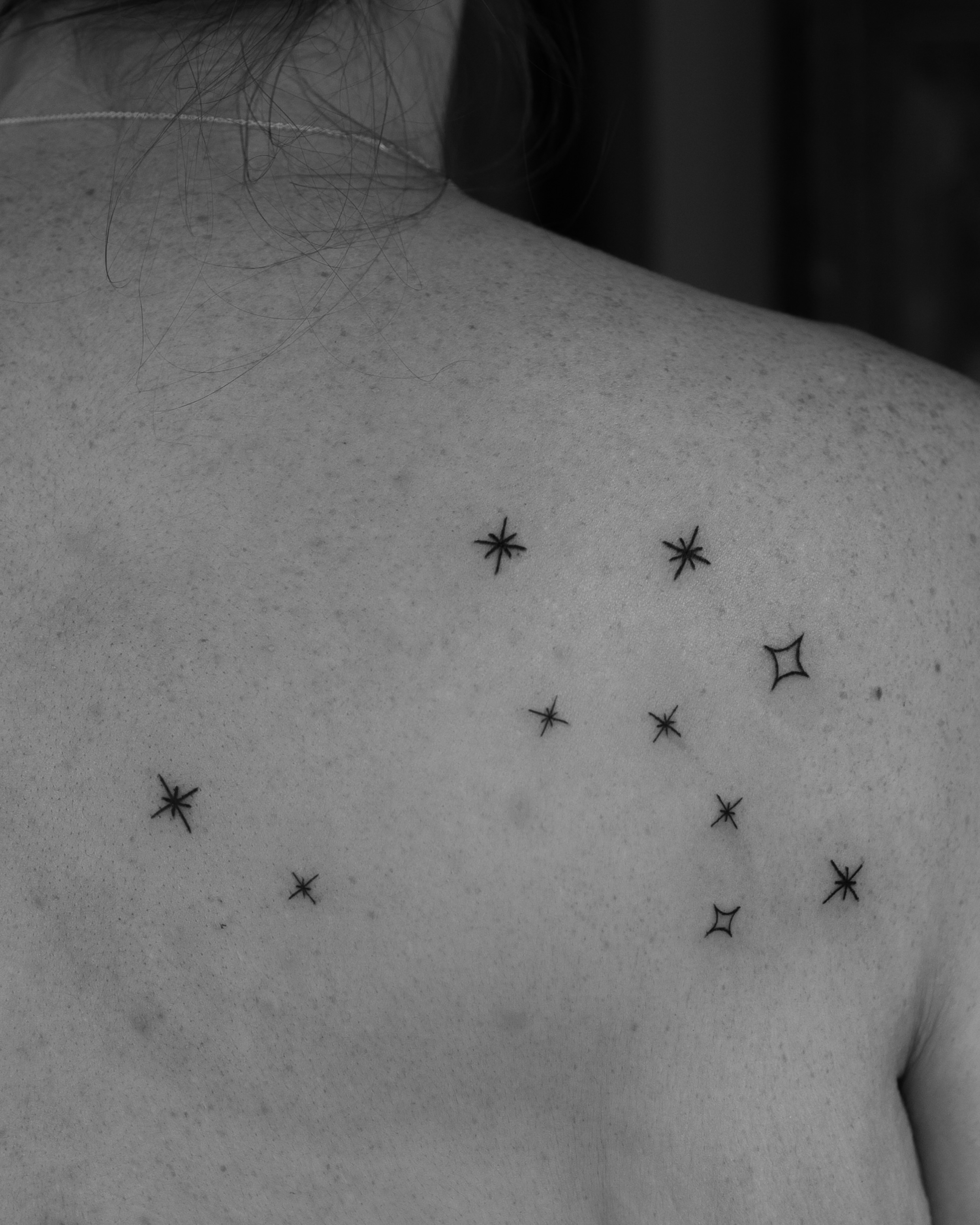 Stars black and grey tattoo on the shoulder by Ash - Fineline Tattoo Apprentice