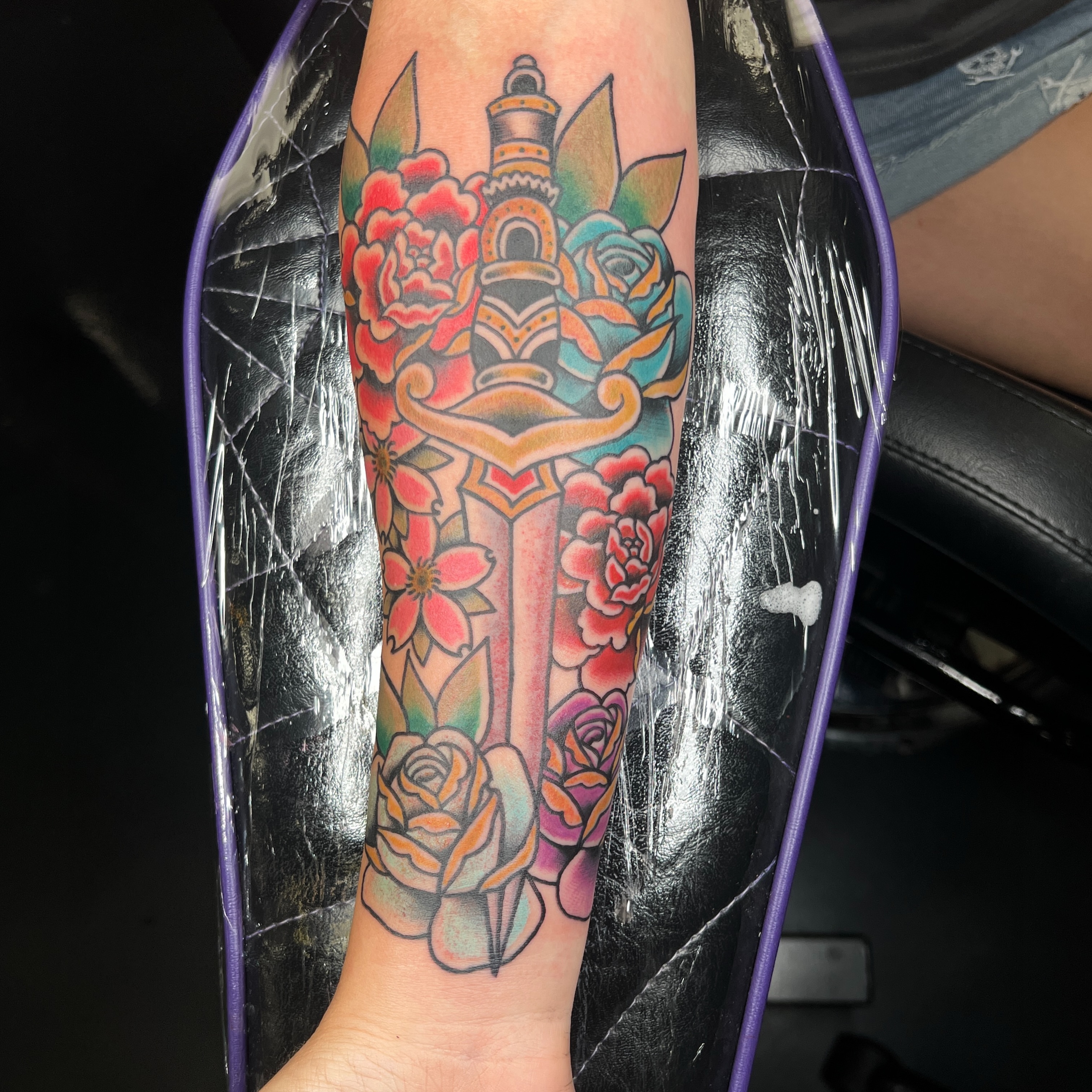 Floral sword American traditional tattoo on the forearm by Brian Mock