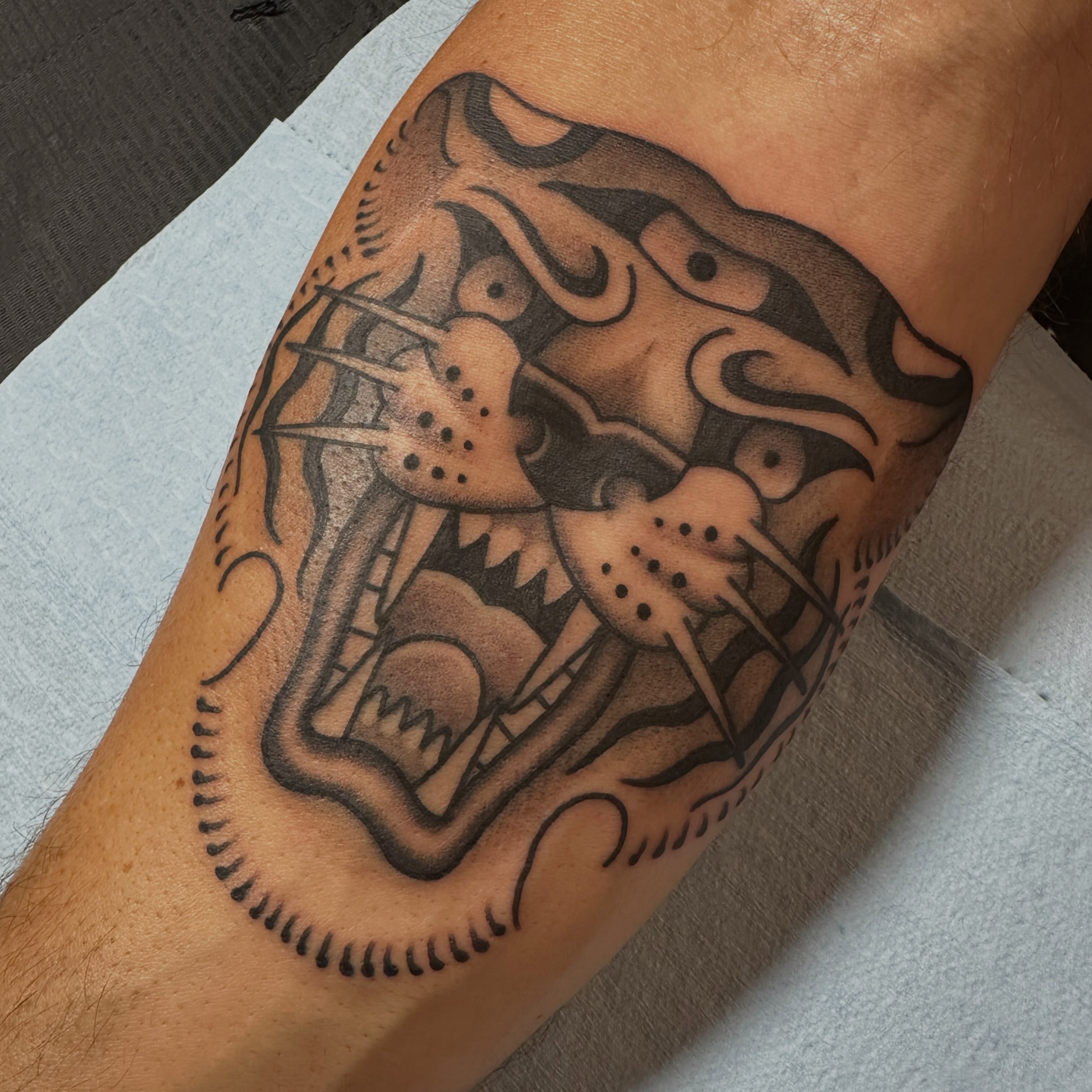 Lion American traditional tattoo on the forearm by Kyle Logan Frary