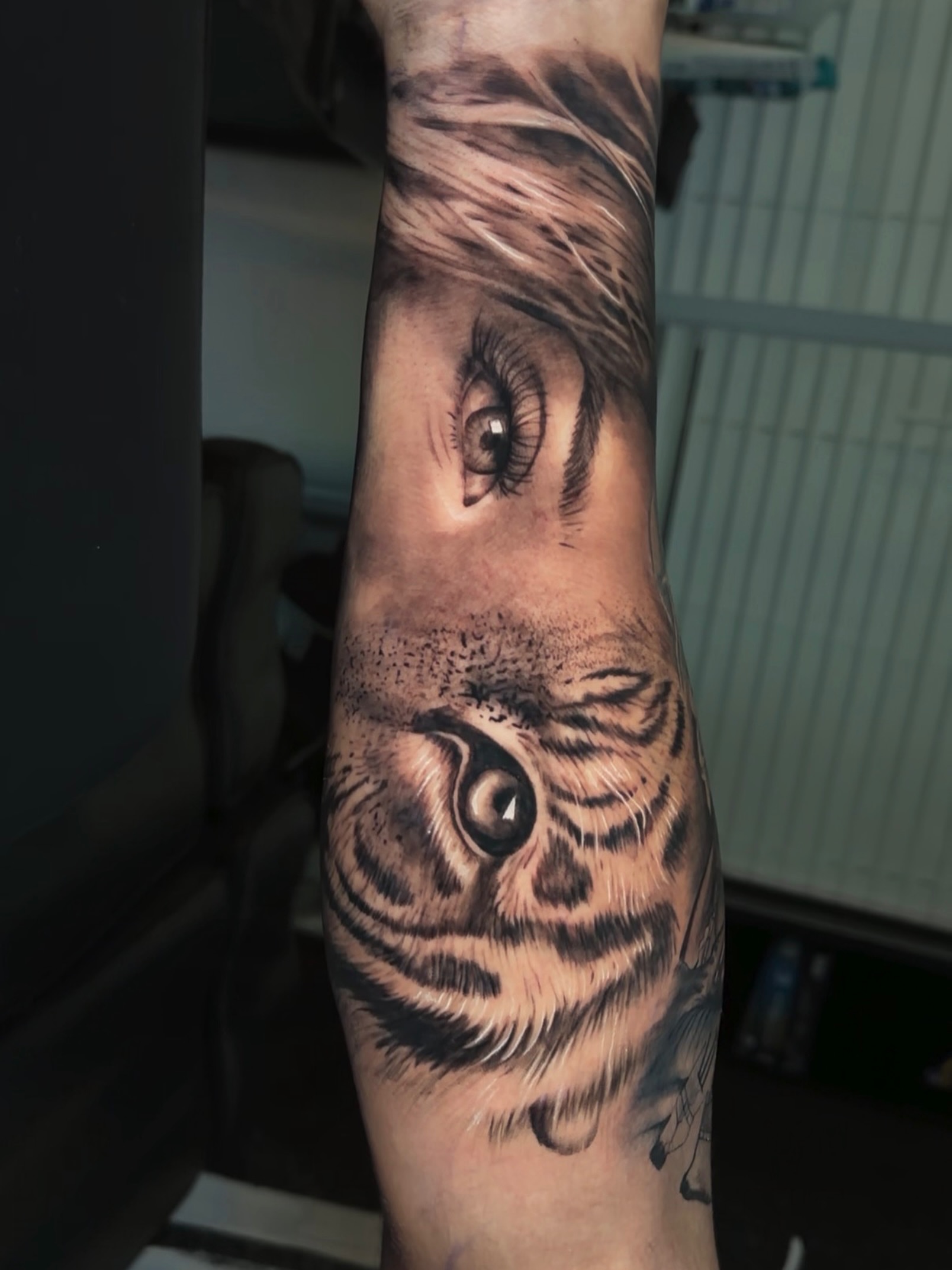 Eye and tiger realism tattoo on the forearm by 🐺