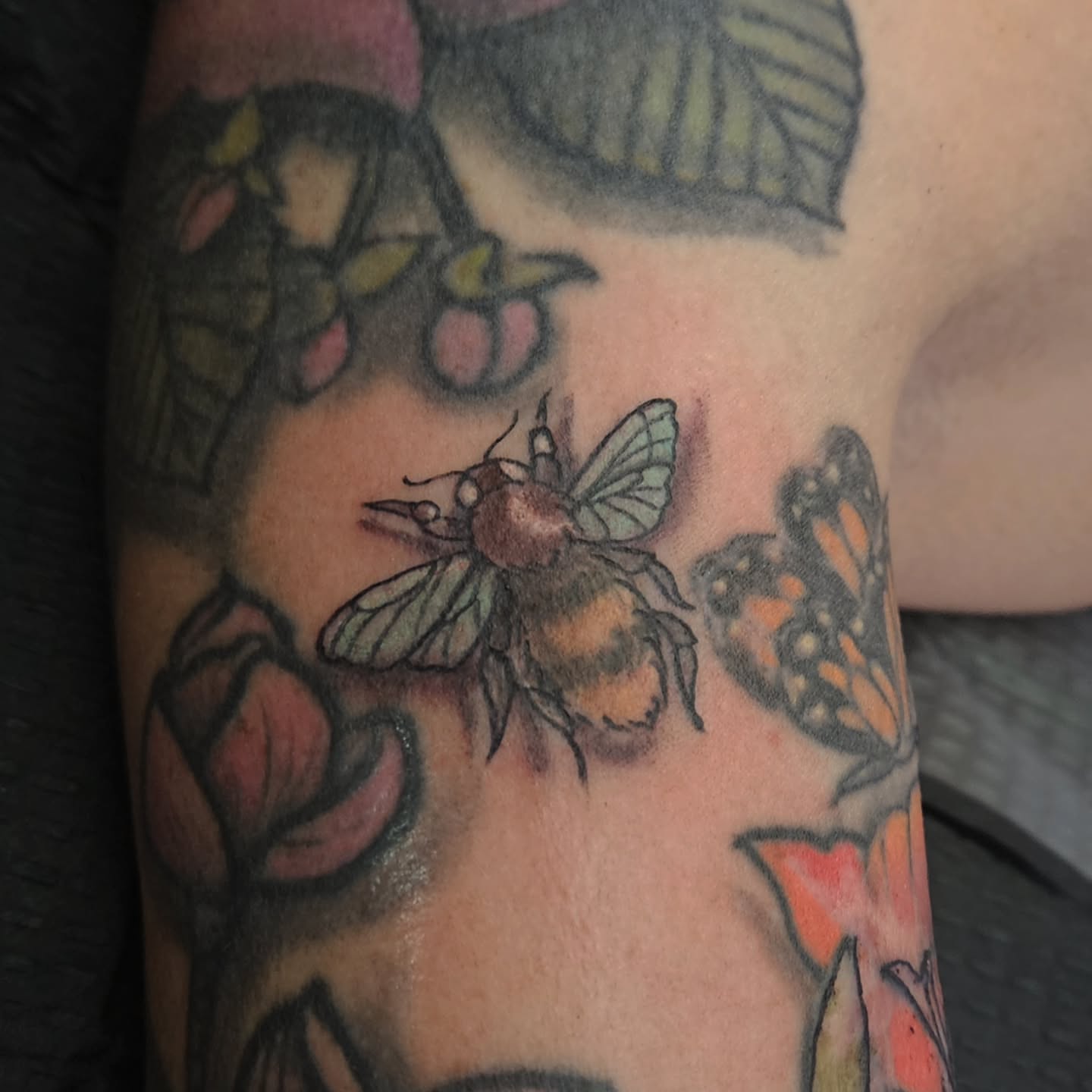 Bee and butterfly American traditional tattoo on the forearm by Shane Watkins