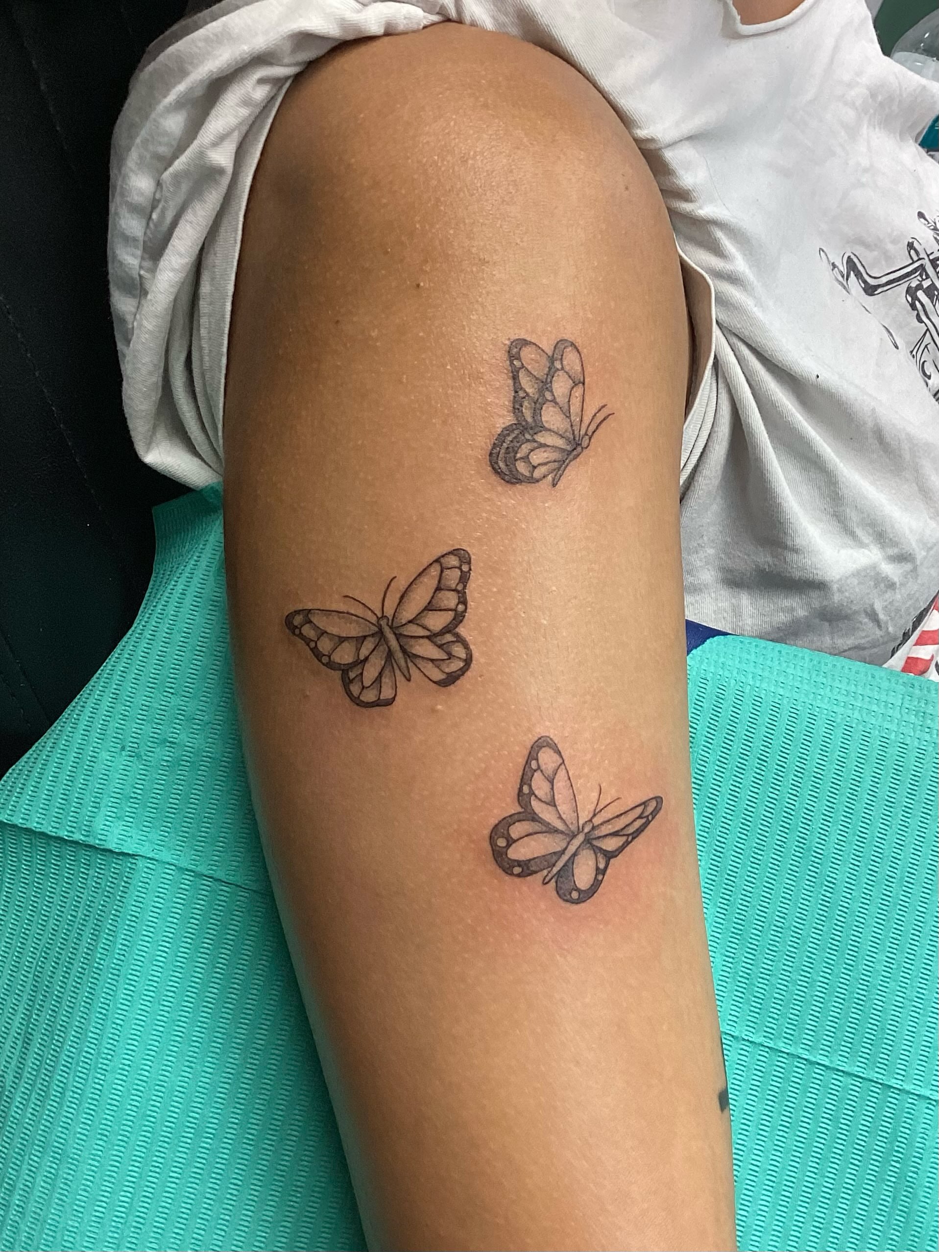 Butterflies black and grey tattoo on the forearm by Amanda Plavan