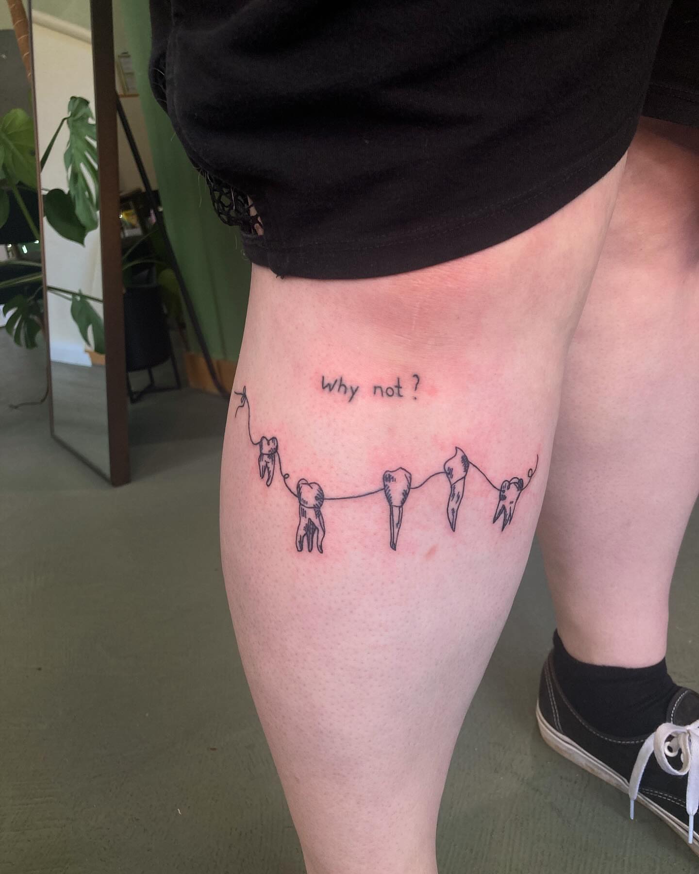 String with hanging teeth dotwork tattoo on the thigh by james <3