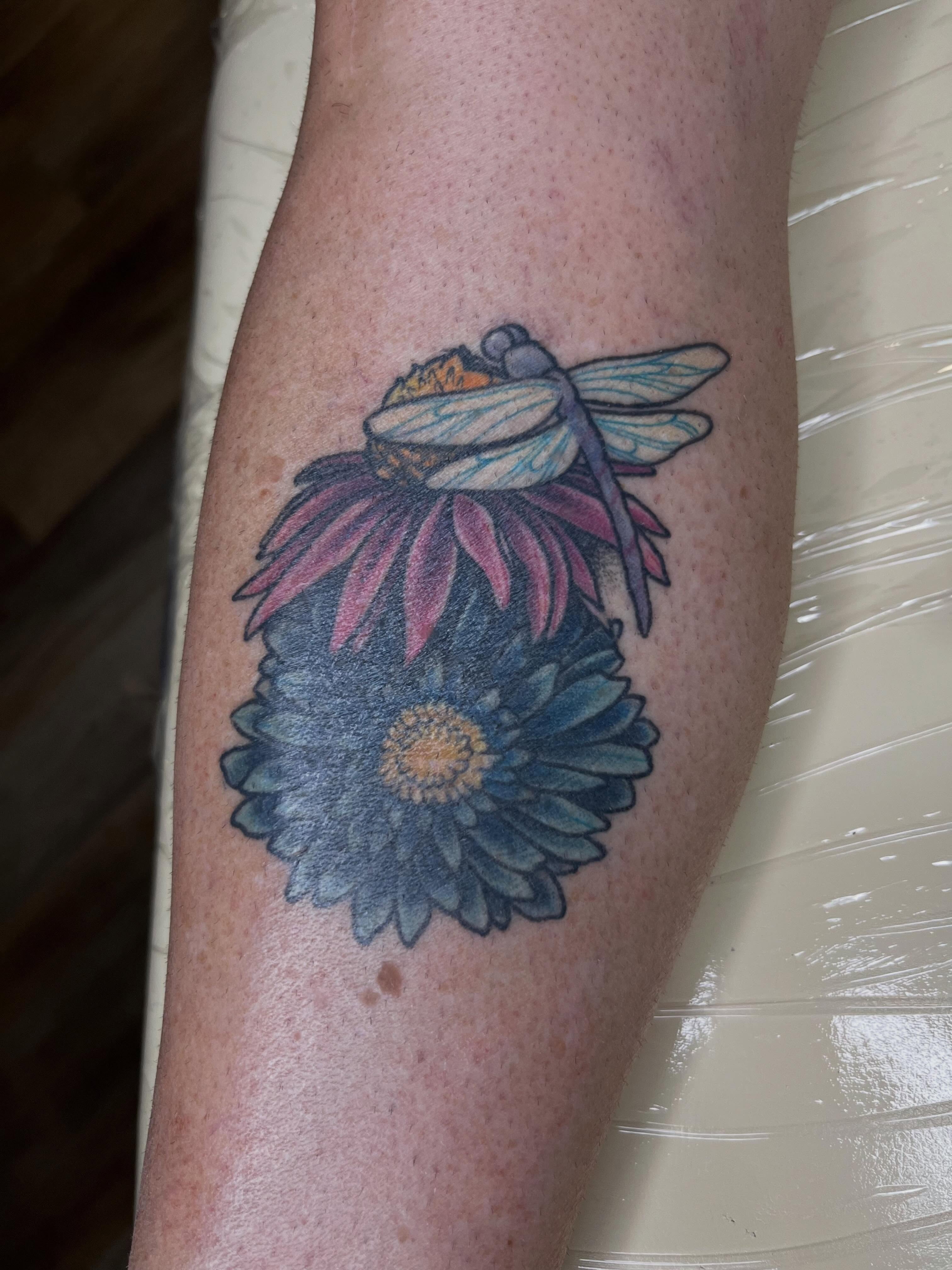 Dragonfly and flowers realism tattoo on the forearm by Taya Lynn, Hudson, Wisconsin