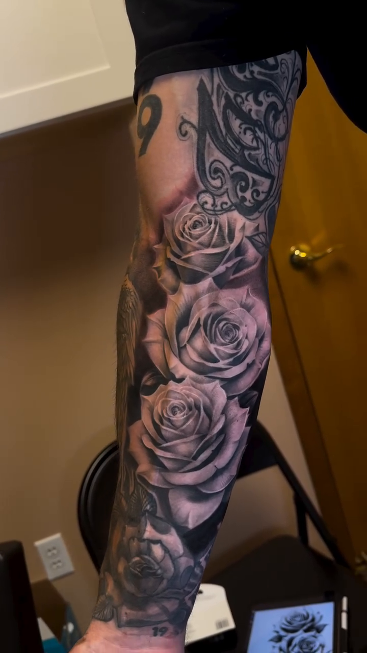 Roses and ornamental elements realism tattoo by Ian Chancellor, Leighton Buzzard, England