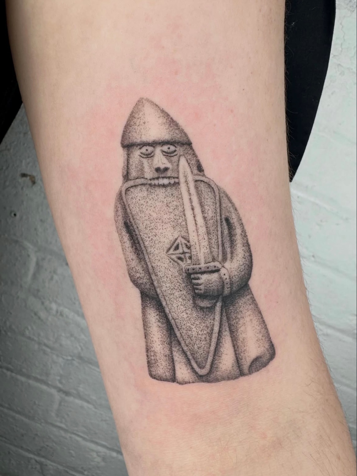 Viking statue dotwork tattoo on the forearm by Kenny ๐ด