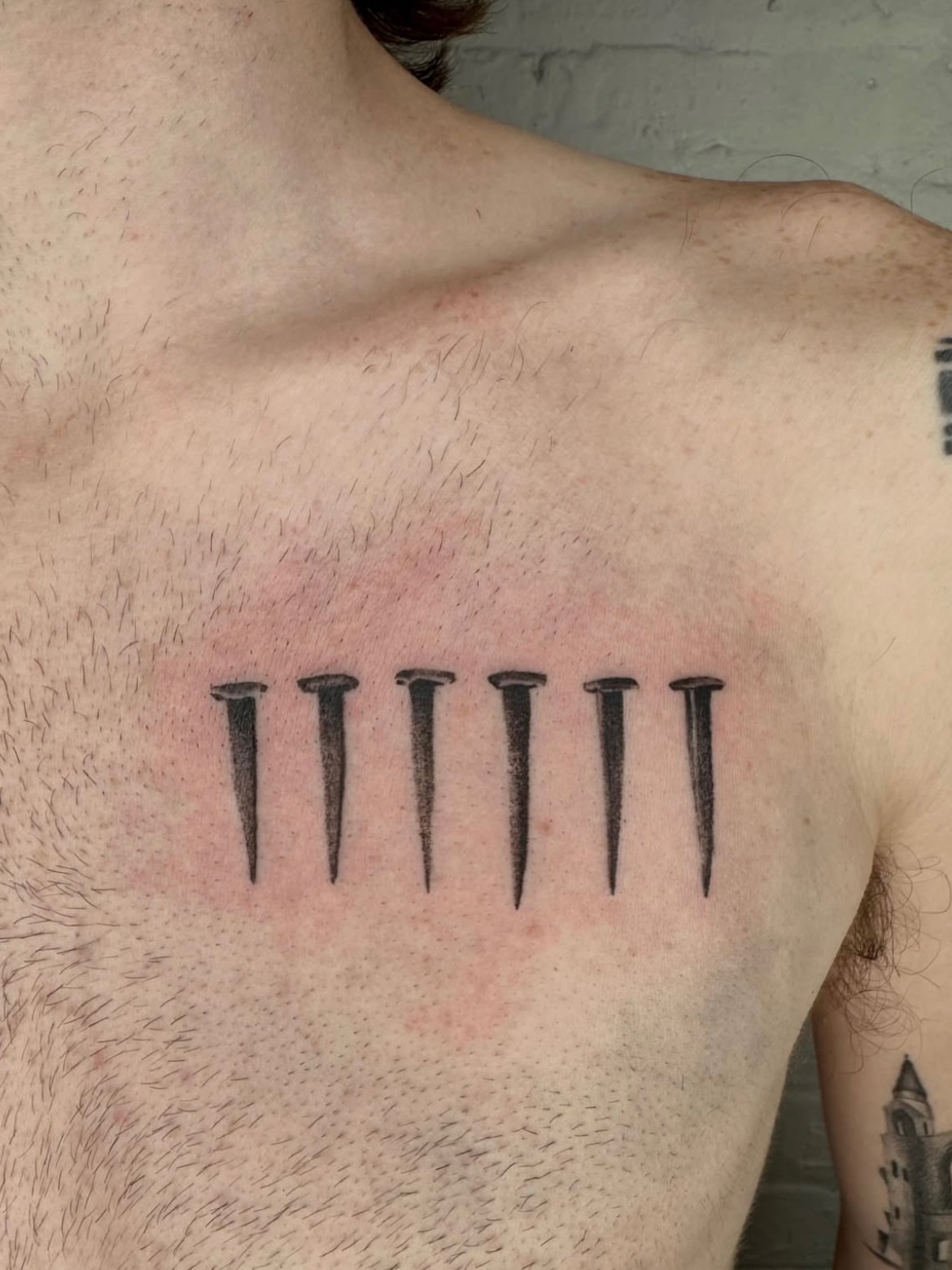 Nails black and grey tattoo on the chest by Kenny ๐ด