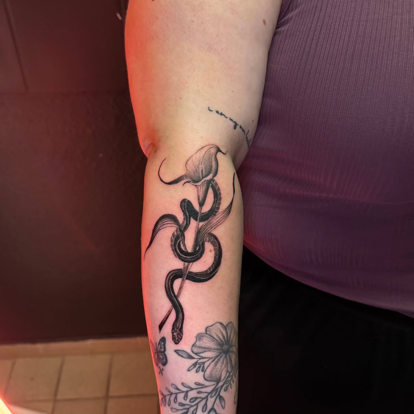 Snake and calla lily black and grey tattoo on the forearm by 🌙 Alessio