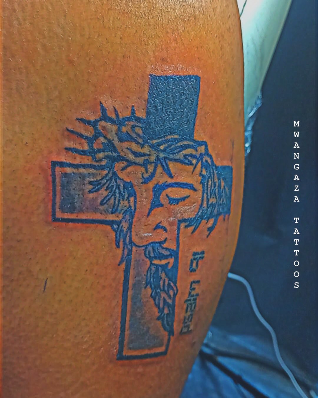Cross with crown of thorns American traditional tattoo on the forearm by Mwangaza Bodyworks, Uthiru, Nairobi Area, Kenya