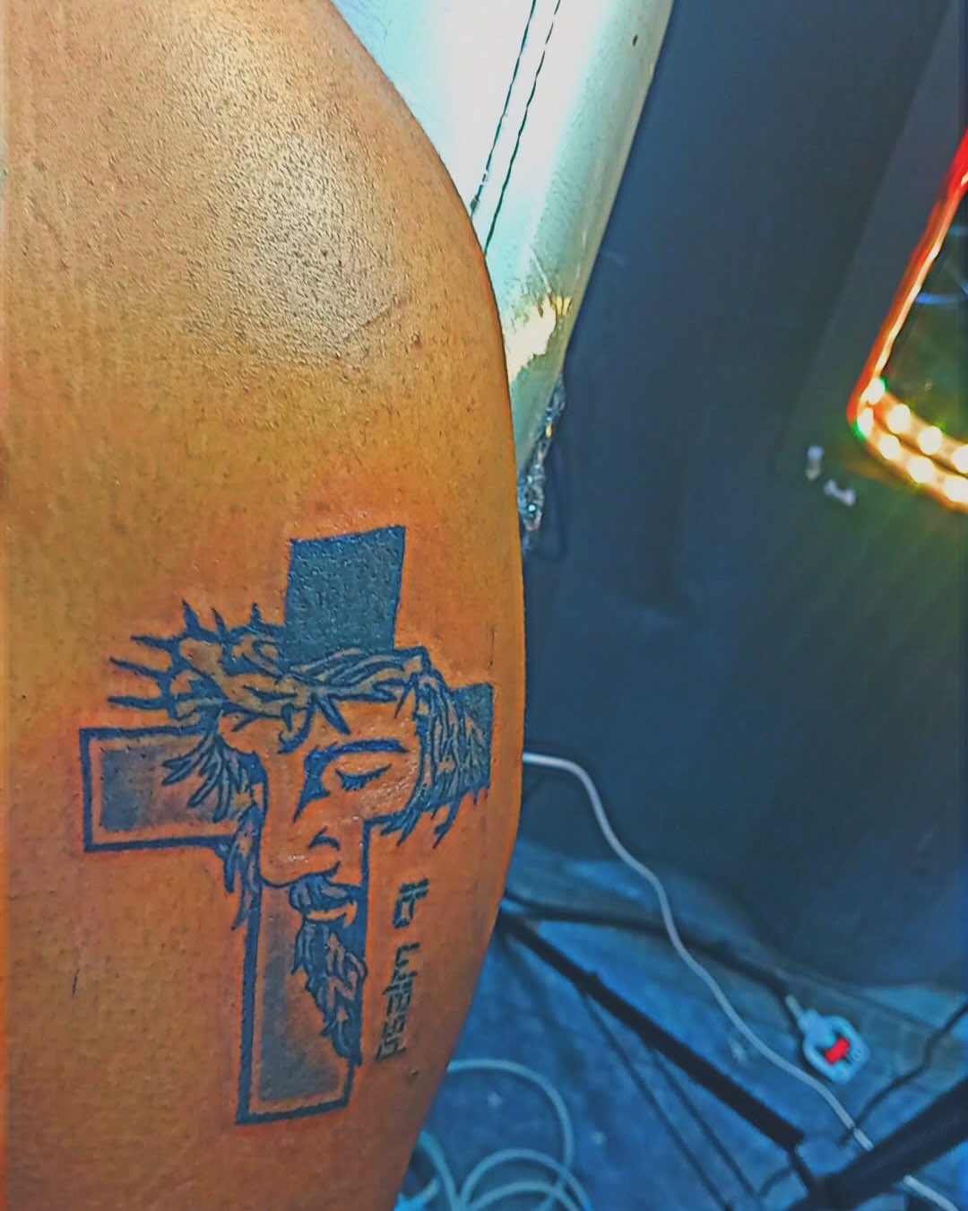 Jesus Christ American traditional tattoo on the upper arm by Mwangaza Bodyworks, Uthiru, Nairobi Area, Kenya