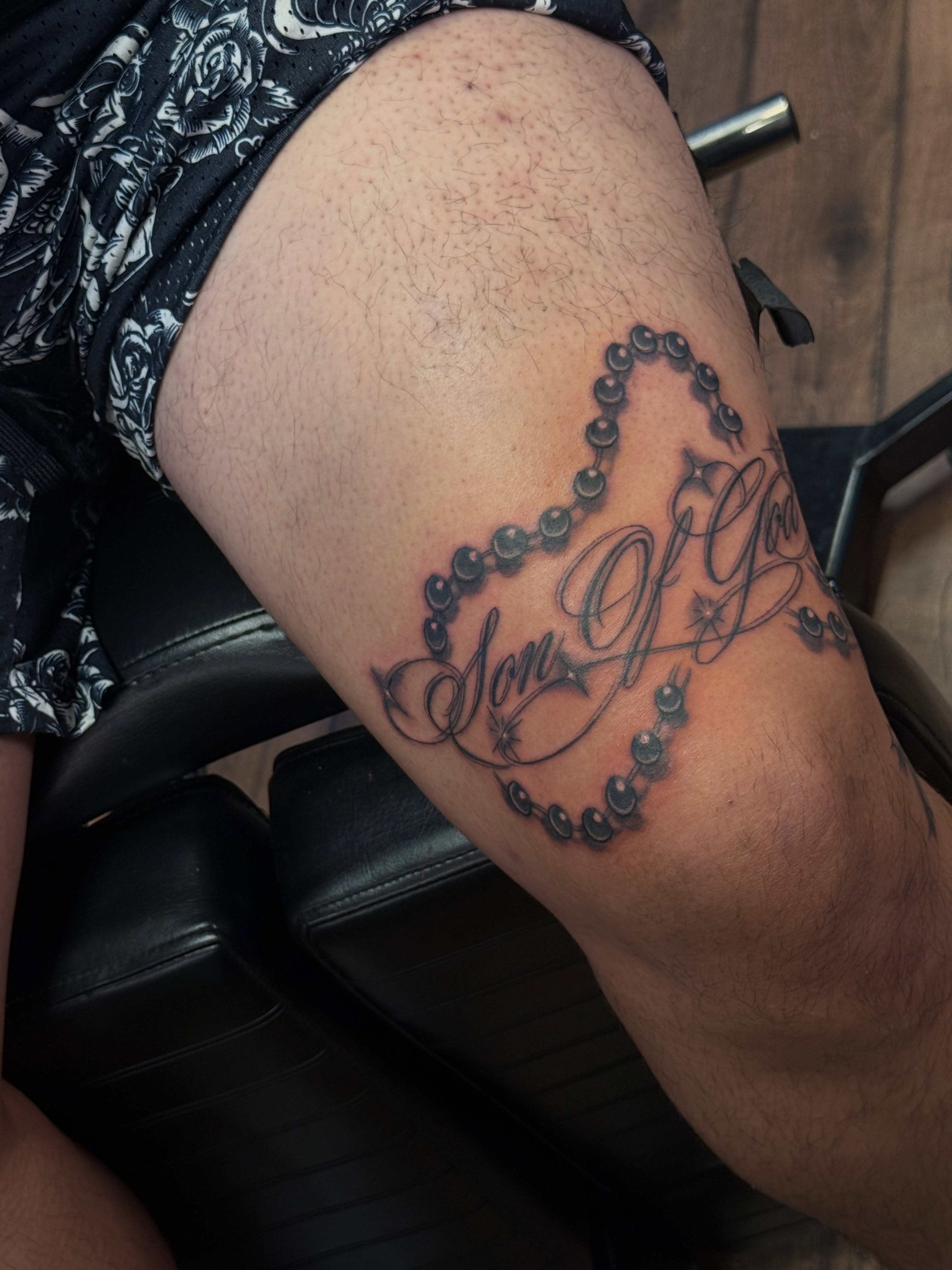 Son of god black and grey tattoo on the thigh by Juan Pablo
