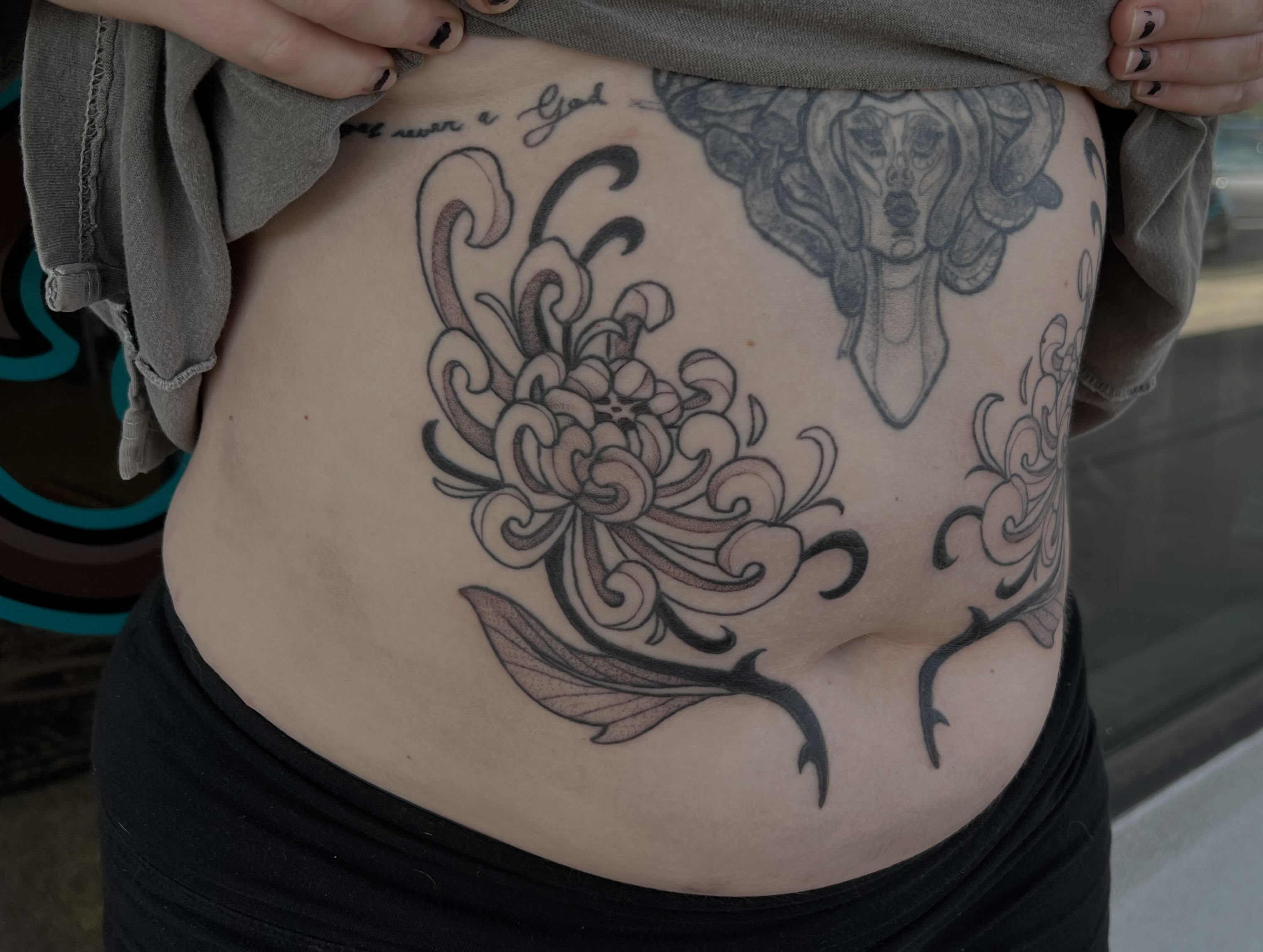 Chrysanthemum black and grey tattoo on the torso by Callie πͺ