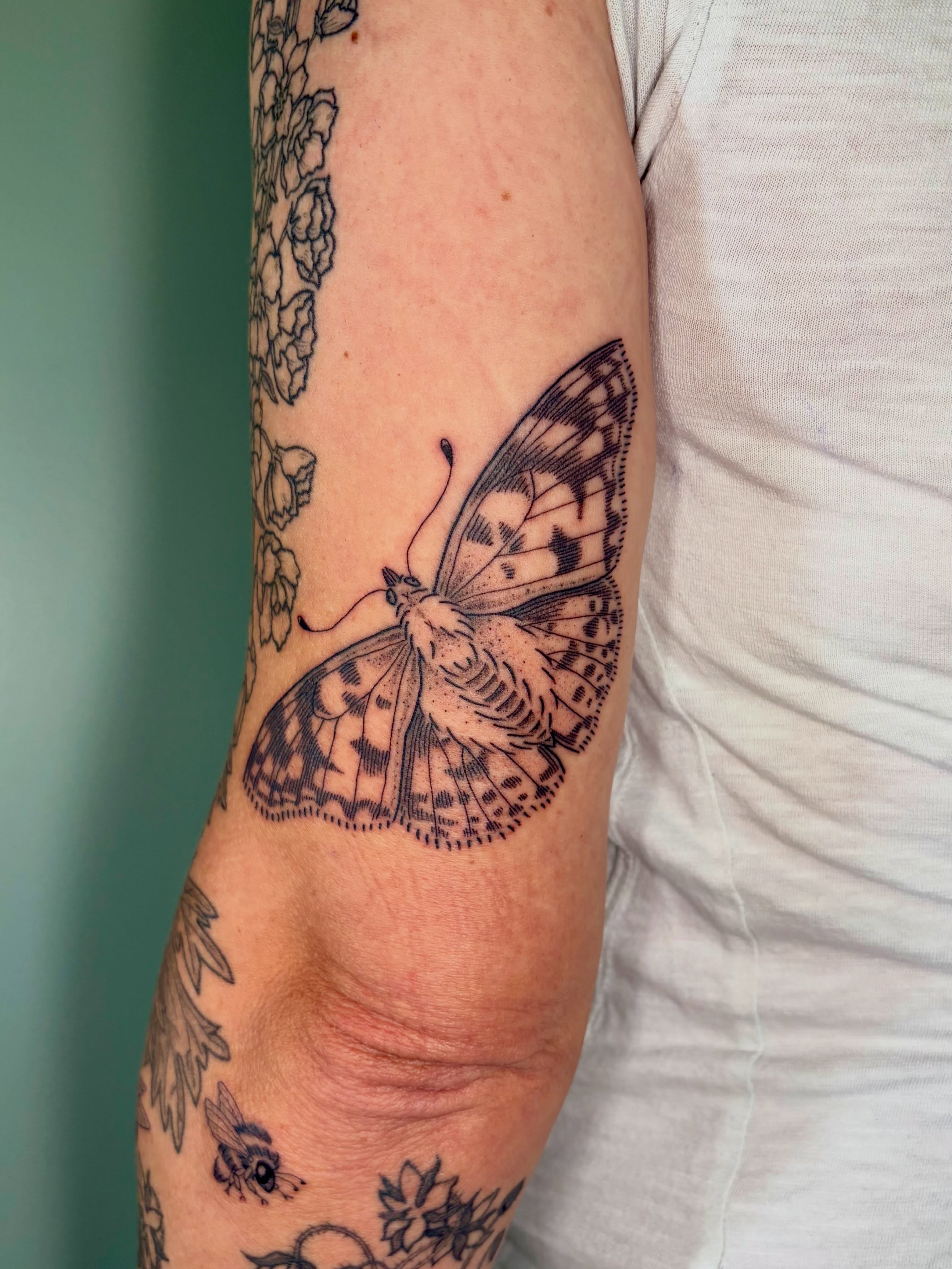 Butterfly black and grey tattoo on the forearm by Sarah Roach
