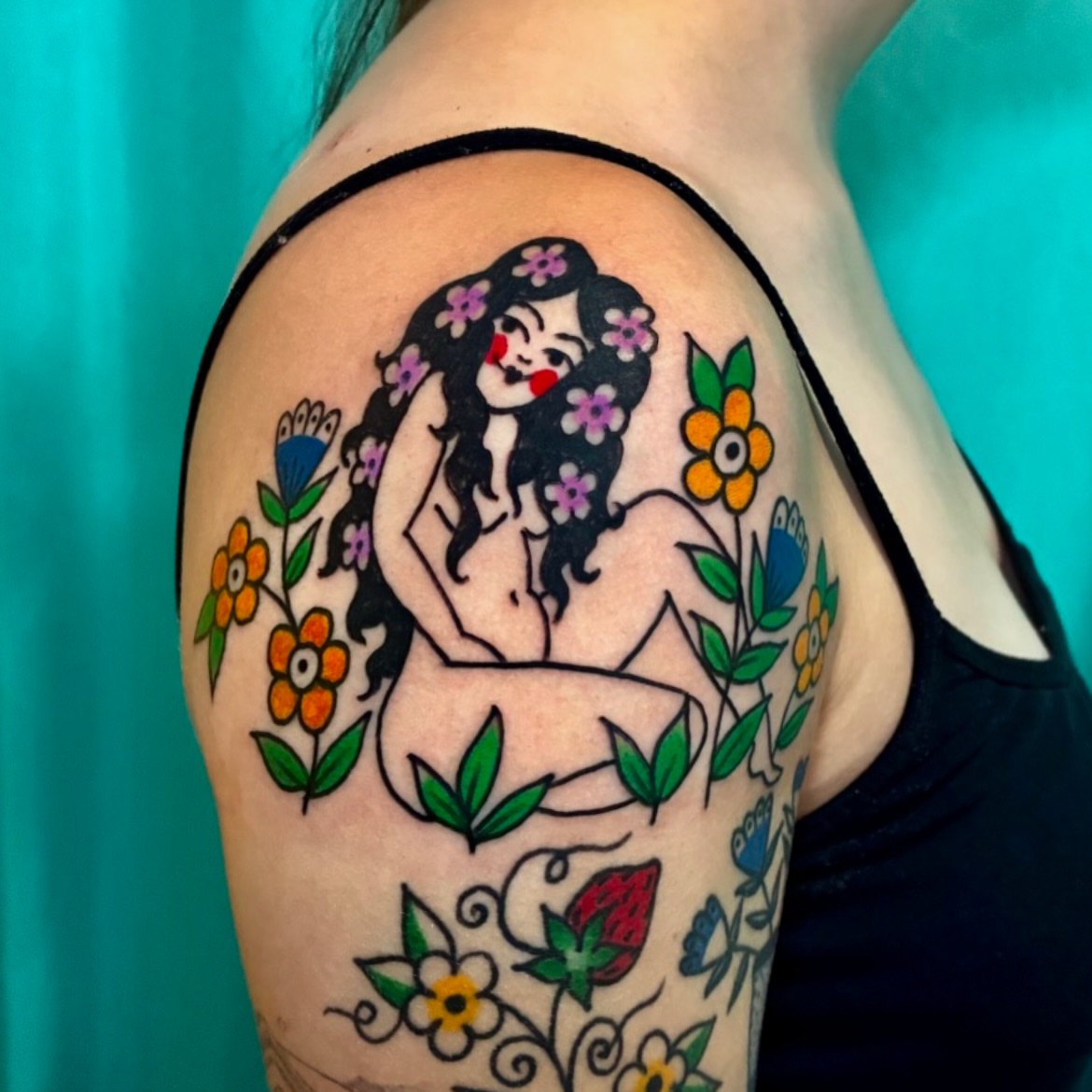 Woman with flowers American traditional tattoo on the shoulder by Kaily McKee