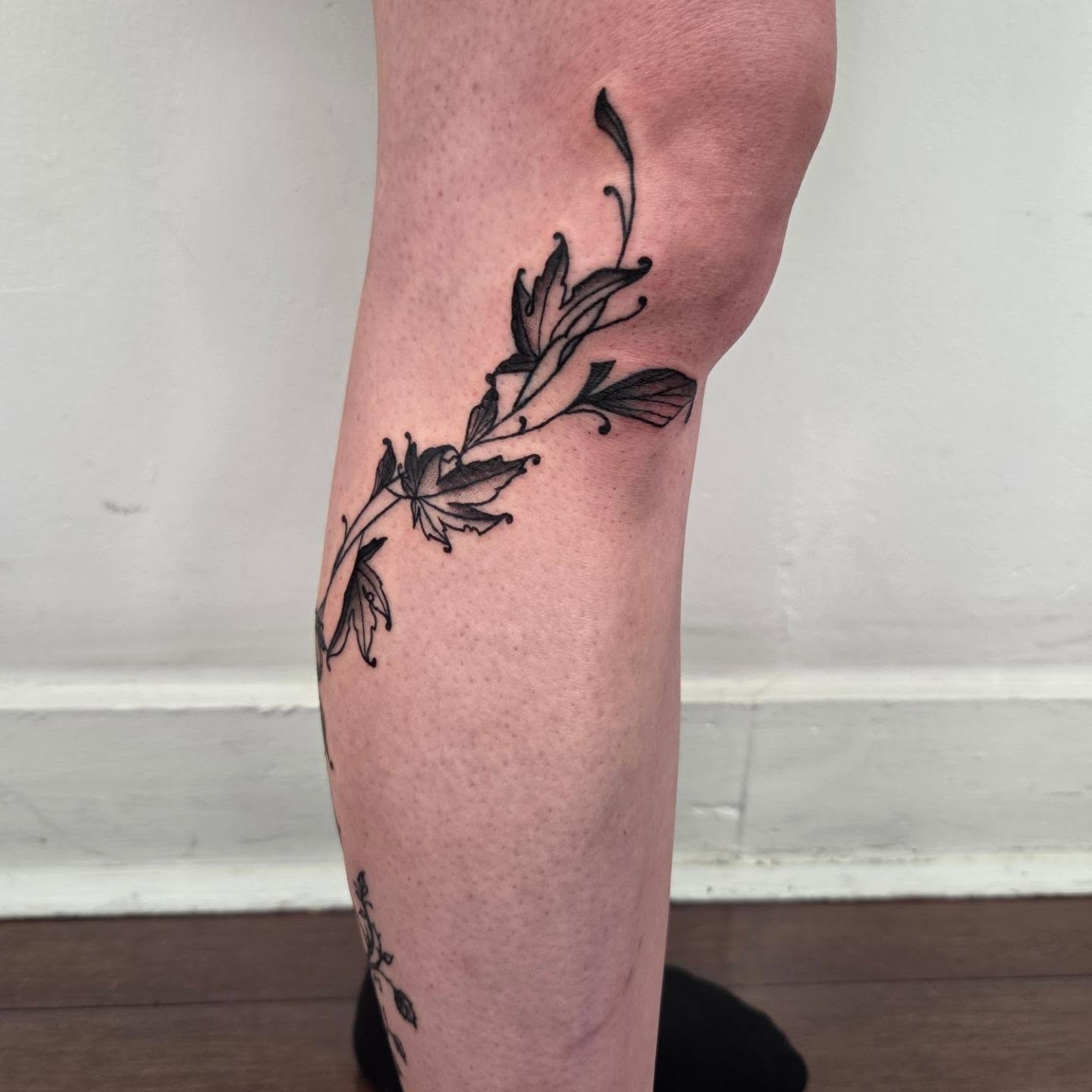 Floral vine black and grey tattoo on the calf by Payton