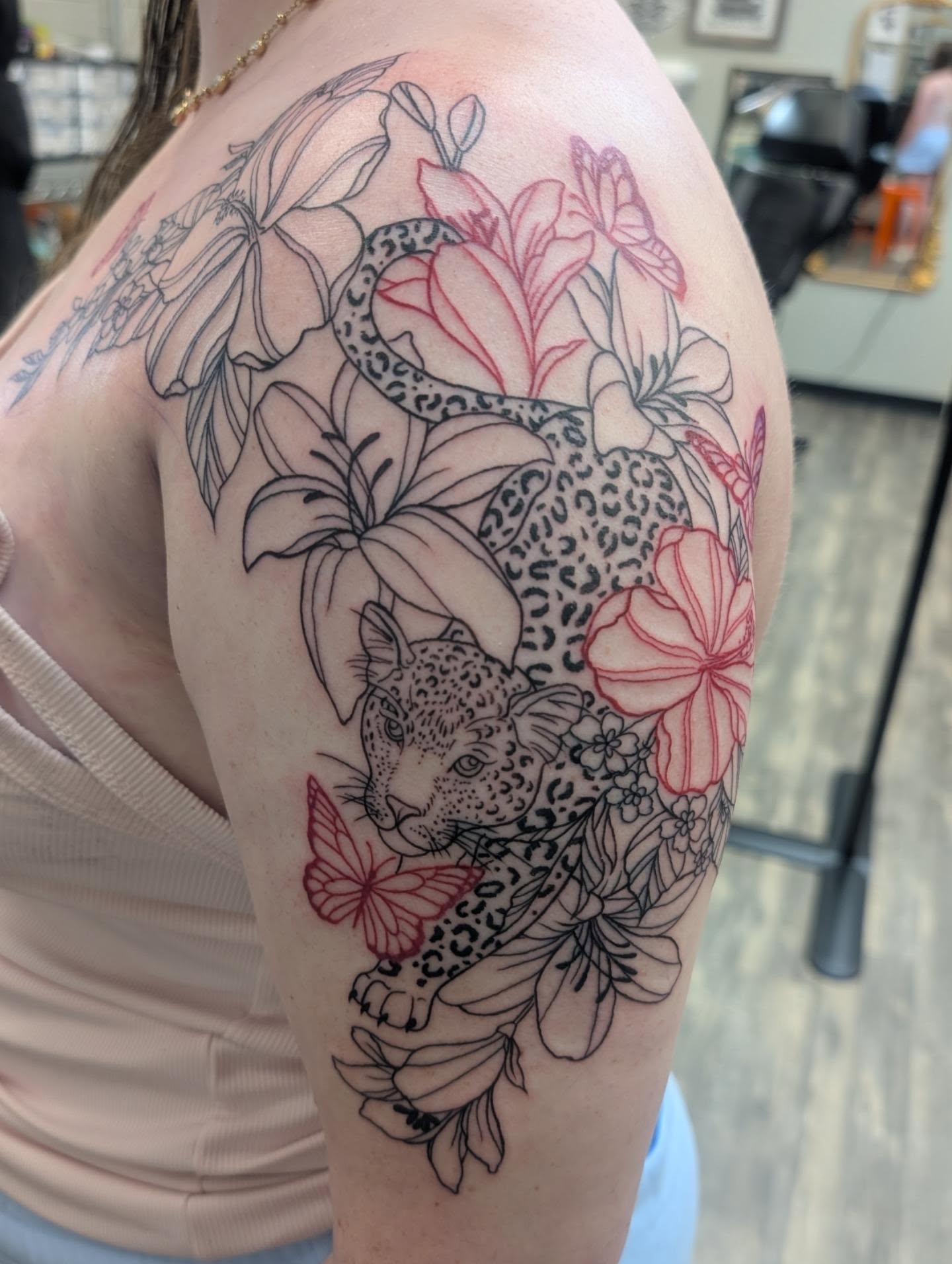 Jaguar and flowers new school tattoo on the shoulder by Talia Zula, Loveland, Ohio