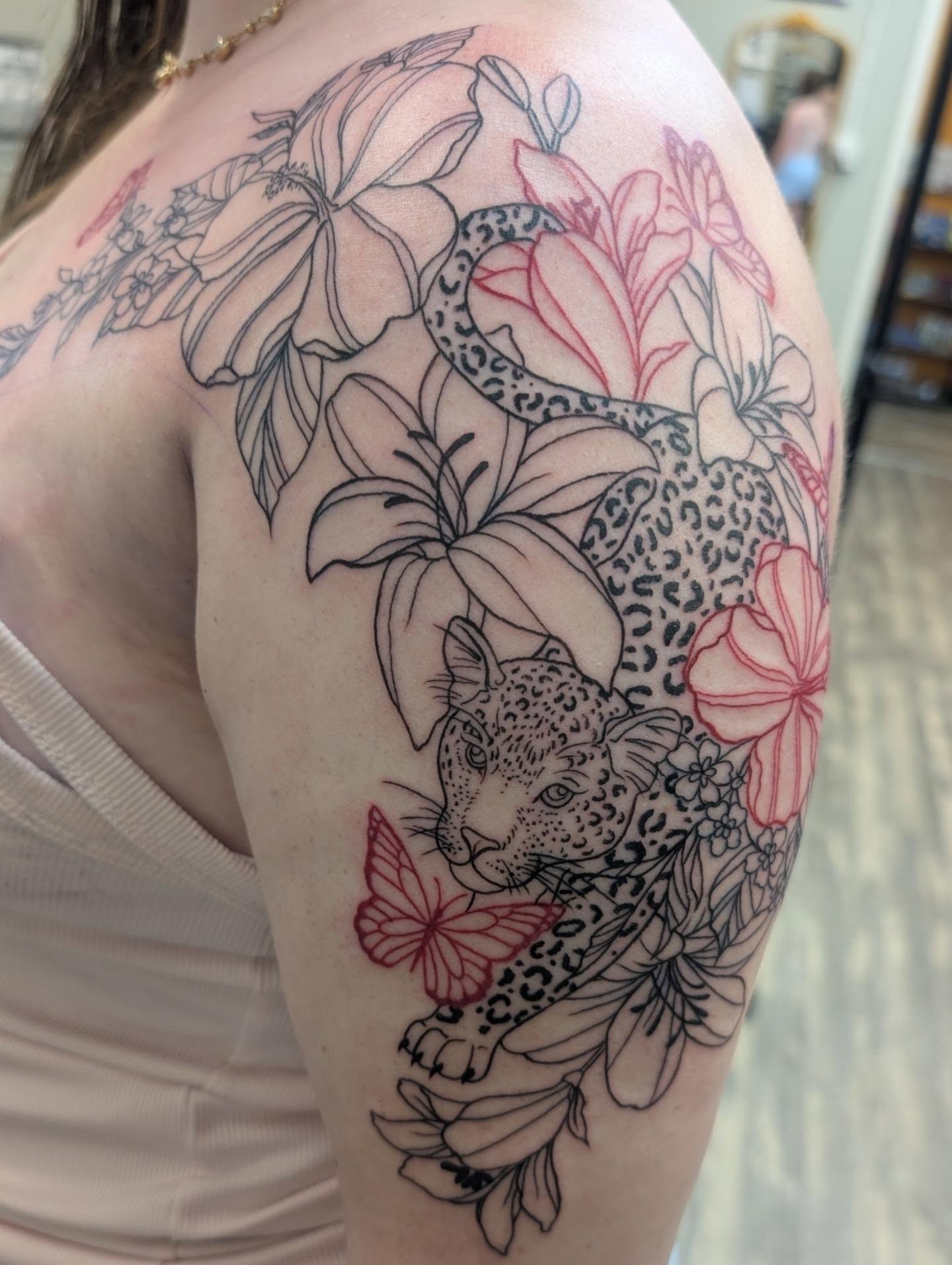Jaguar and flowers dotwork tattoo on the shoulder by Talia Zula, Loveland, Ohio
