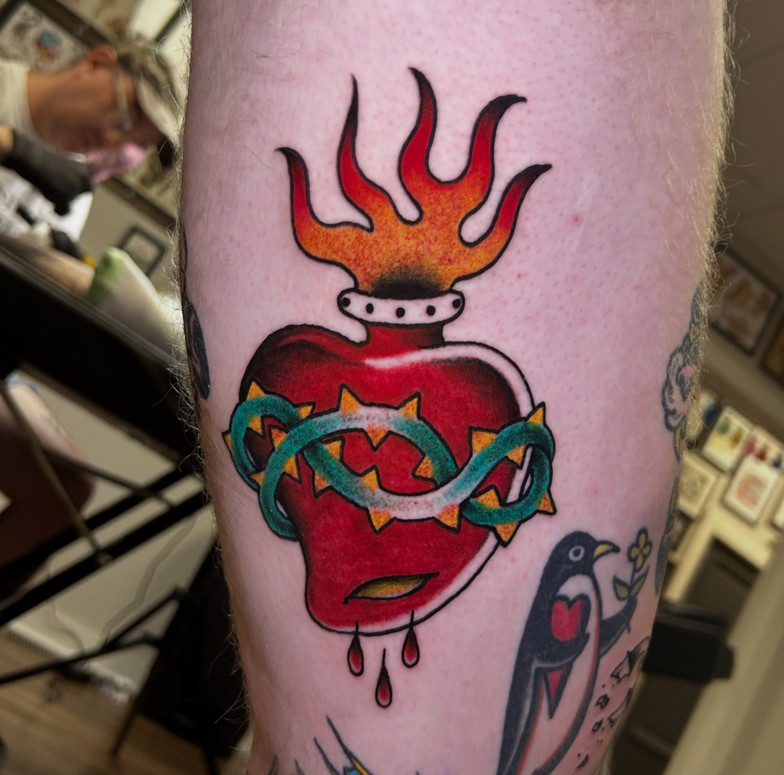 Flaming heart American traditional tattoo on the forearm by Sarah π€π»