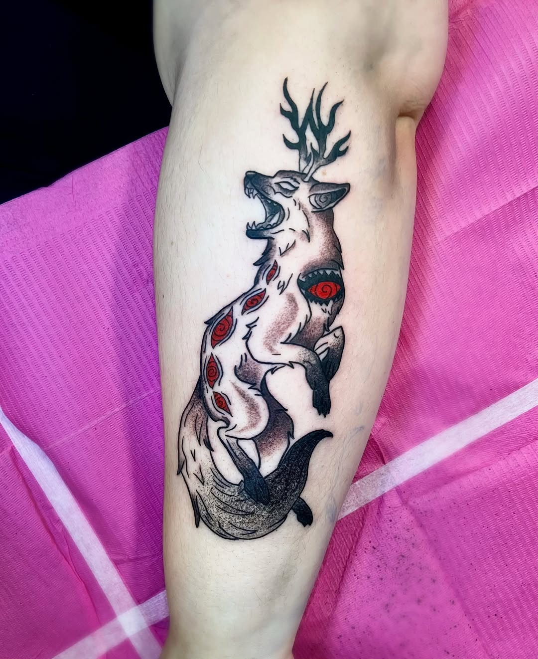Stag and wolf black and grey tattoo on the forearm by Shay Cole