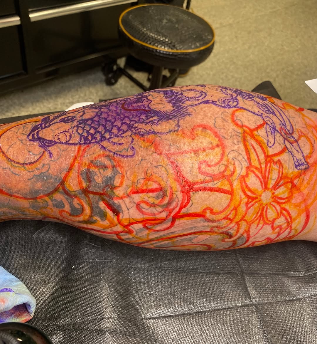 Koi fish and floral design japanese irezumi tattoo on the forearm by Hayden Earley