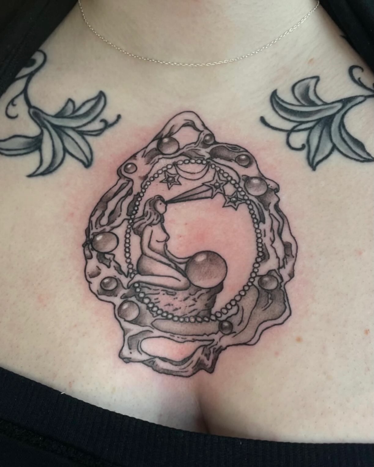 Astronomical figure black and grey tattoo on the chest by Avalon Sable