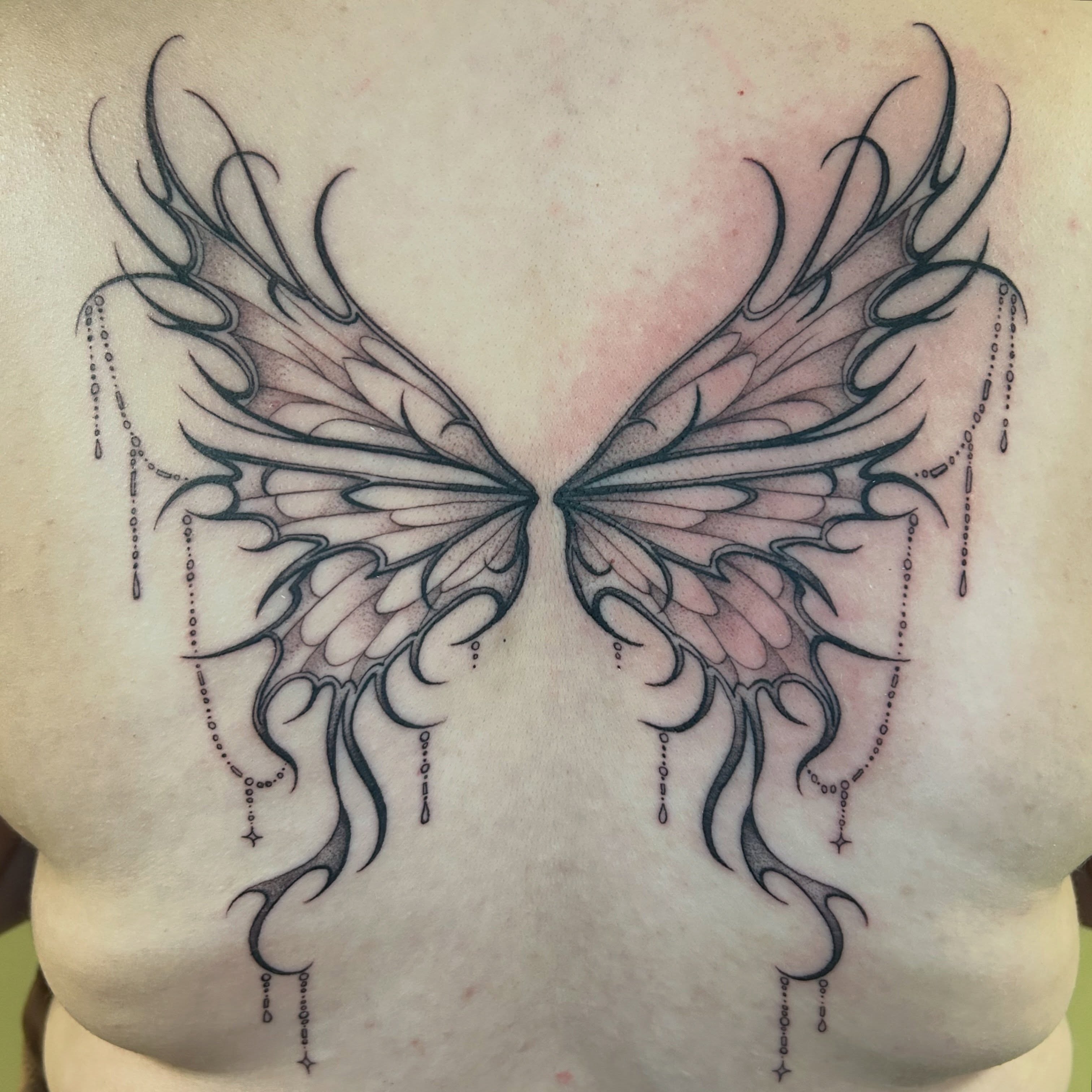 Wings tribal tattoo on the chest by Cassy D, Miami, Florida