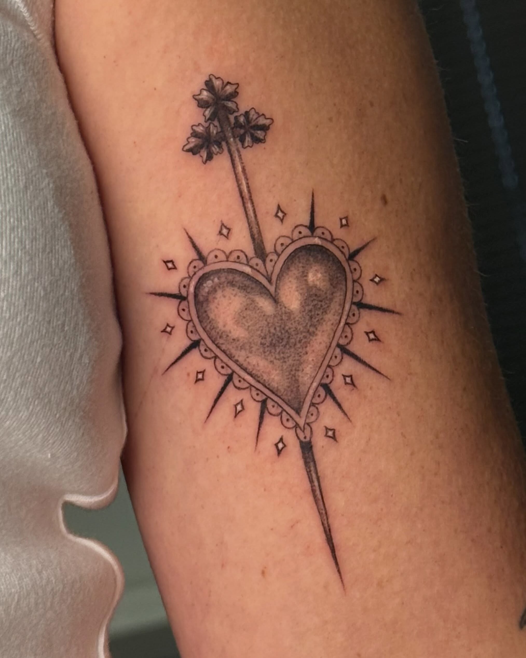 Heart with cross black and grey tattoo on the forearm by Christian
