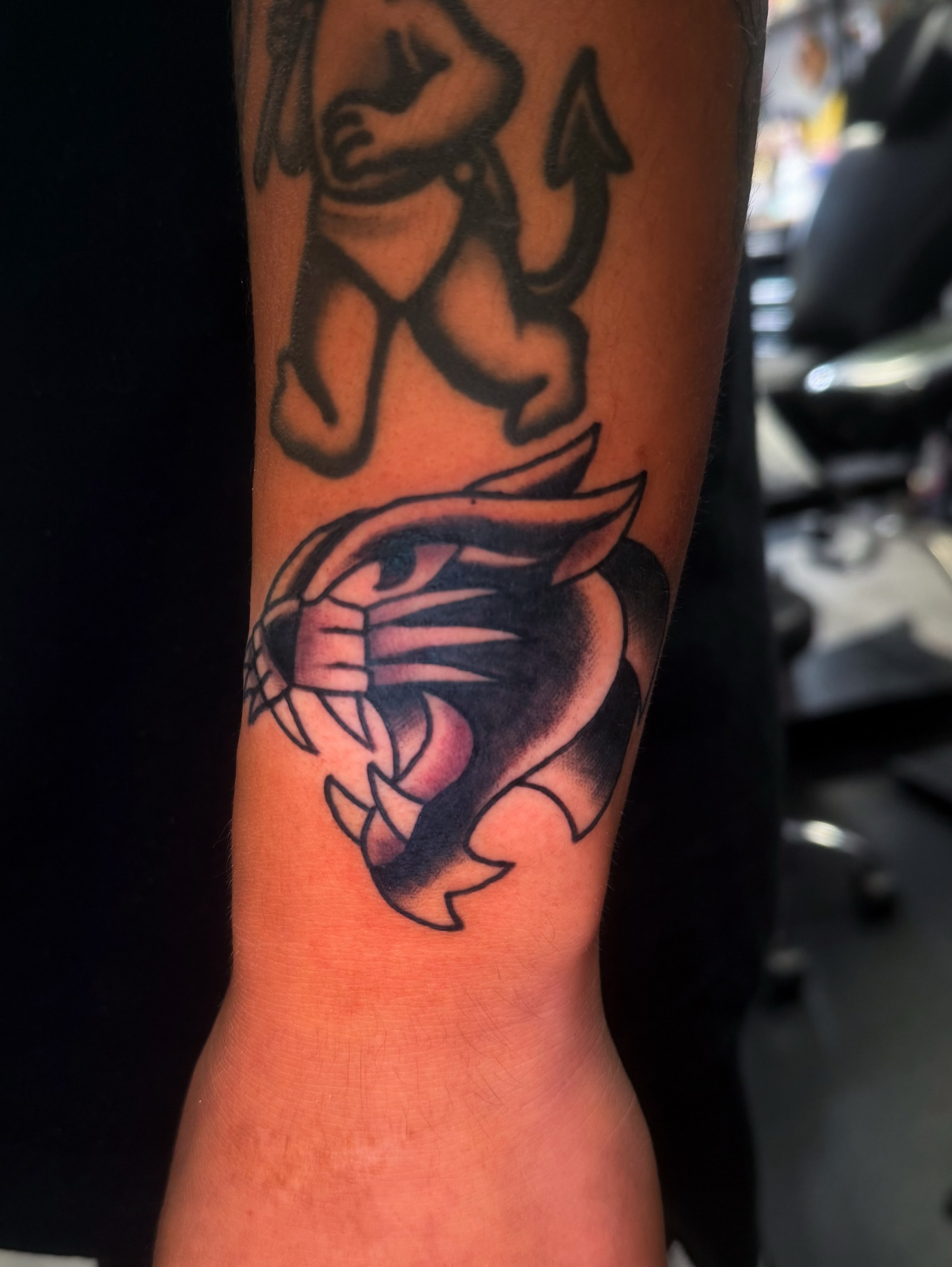 Panther black and grey tattoo on the forearm by Louie Flores